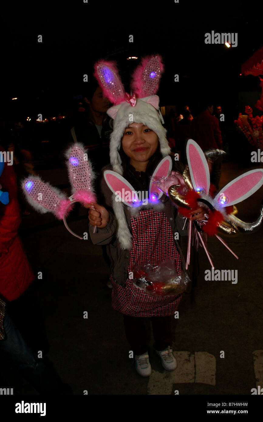 Chinese Students selling rabbit ears toys Flower market durring Chinese New Year Stock Photo
