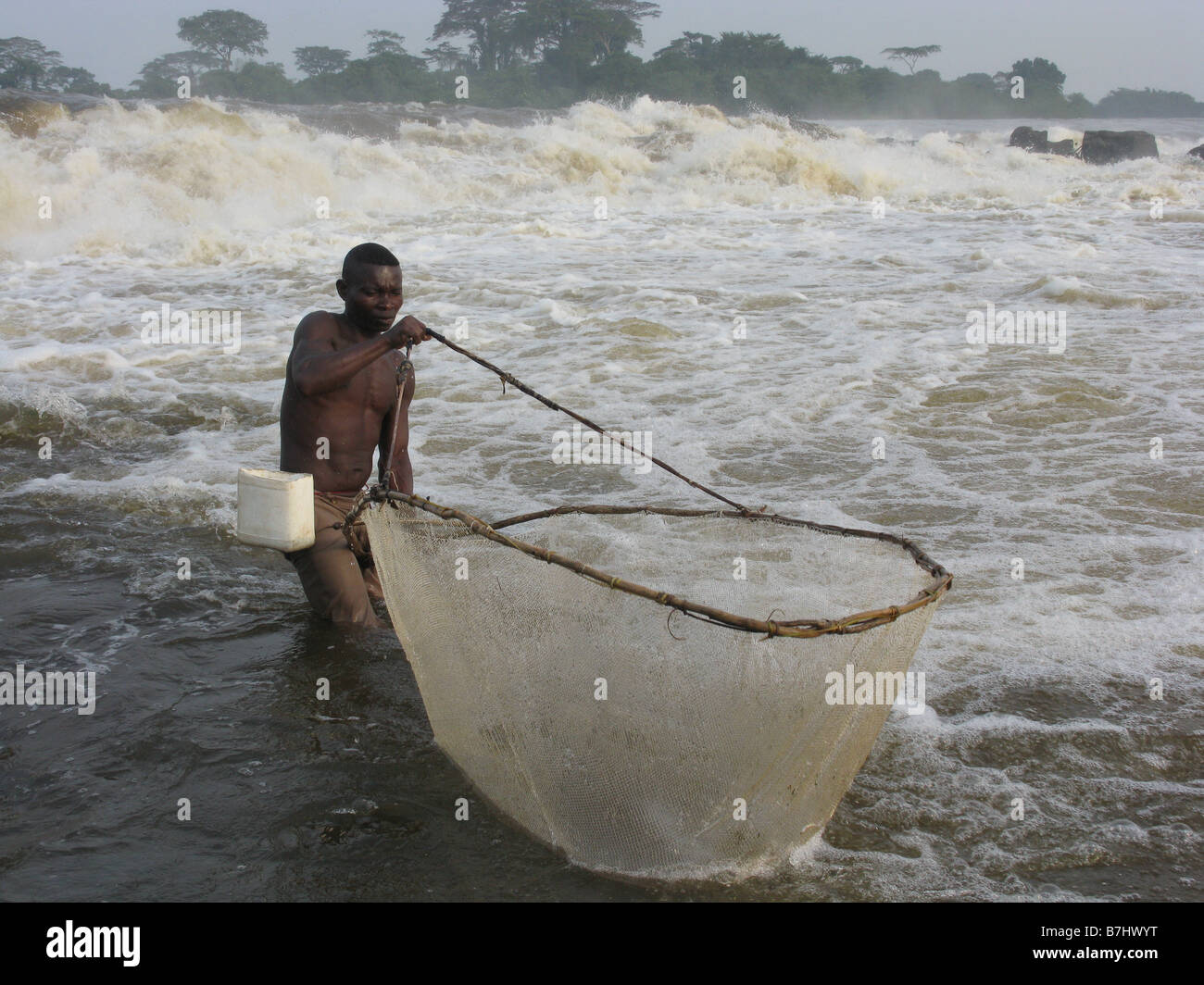 Wagenia fisherman using scoop net at Stanley Falls Chutes Boyoma on River Congo Democratic Republic of Congo at Kasangani Stock Photo