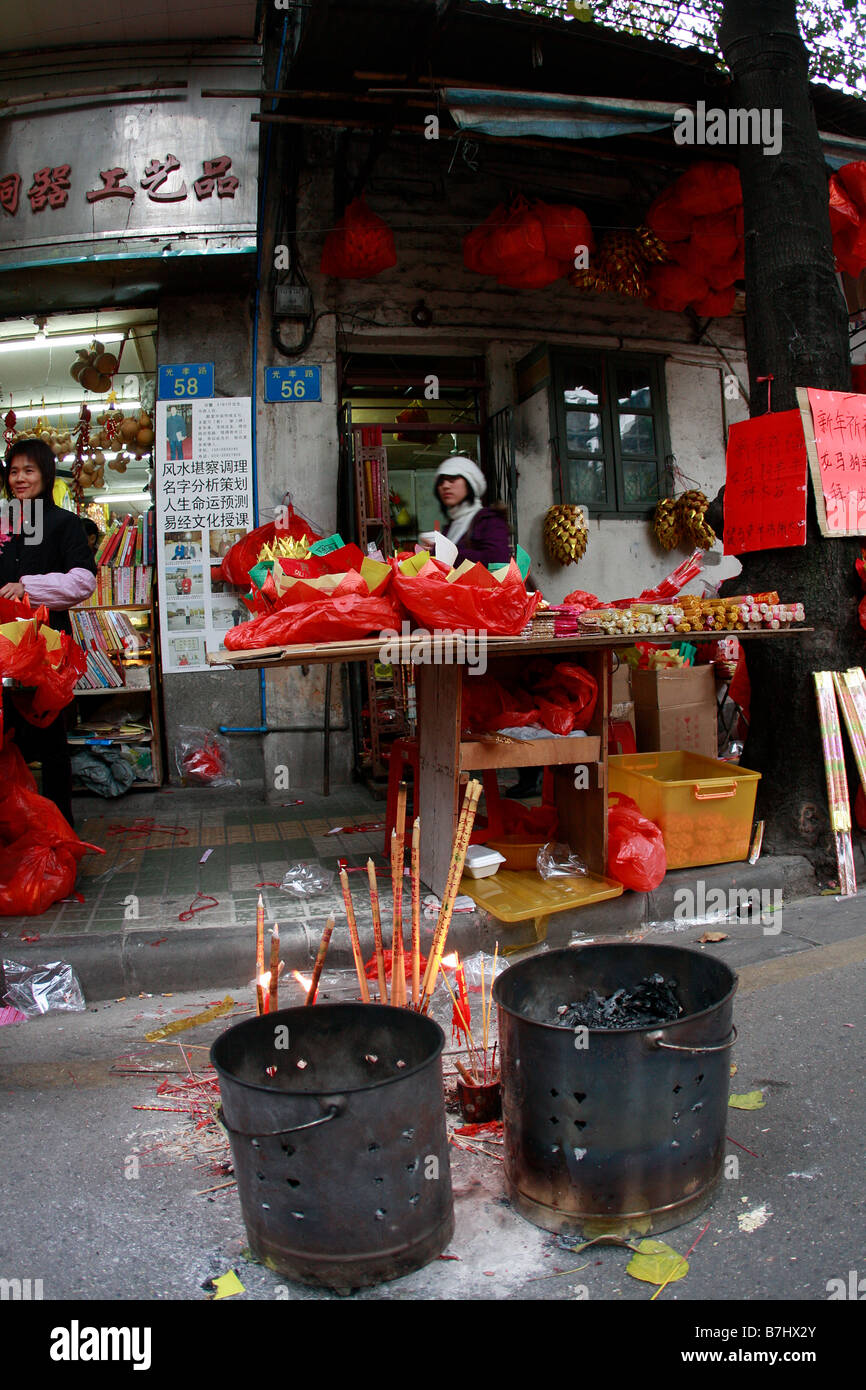 People worshipping the Beginning of the CHinese New YEar On The streets in China Stock Photo