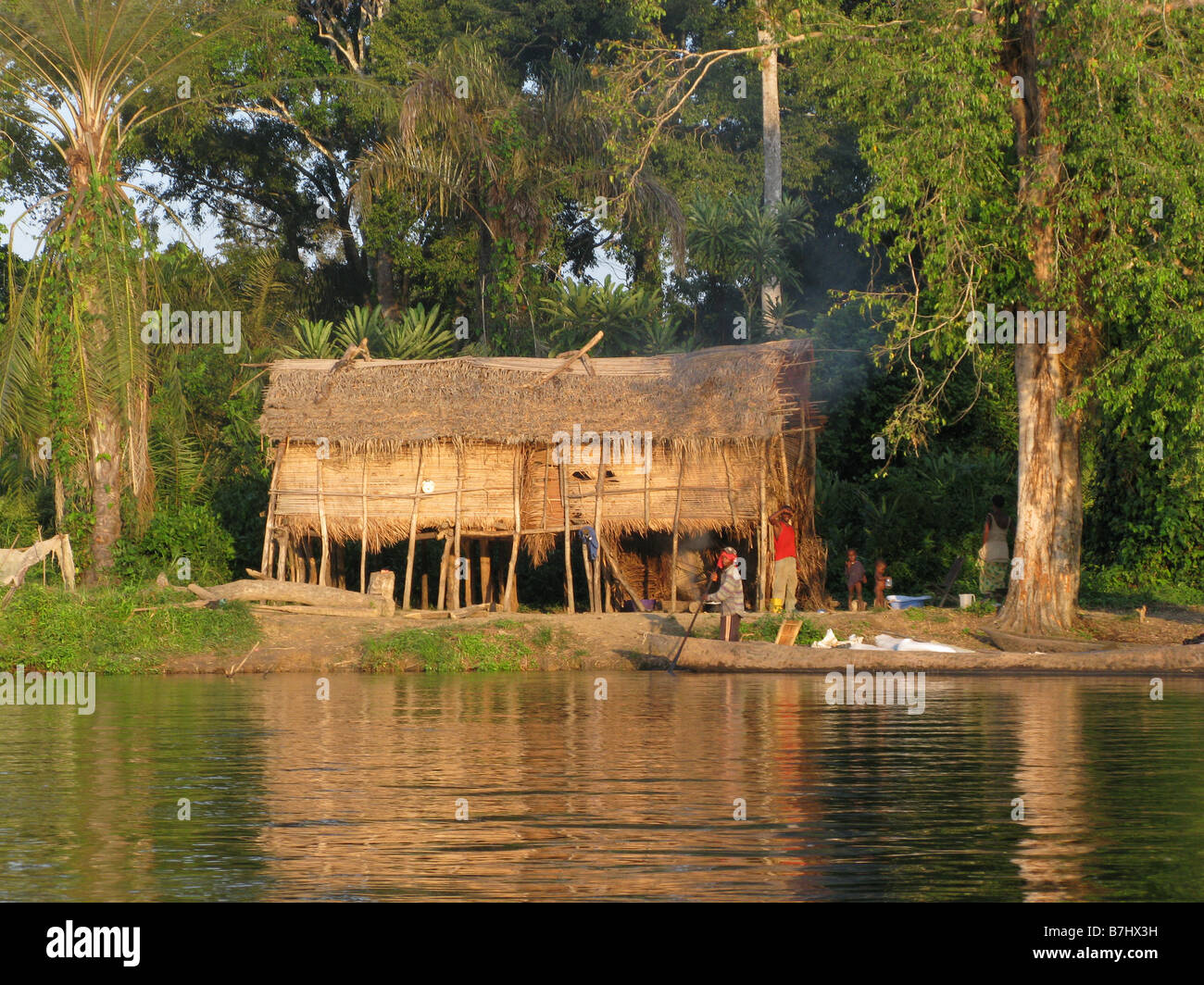 Fishing village thatched roofed huts of grass and reeds set on stilts on bank of Congo River Democratic Republic of Congo Stock Photo