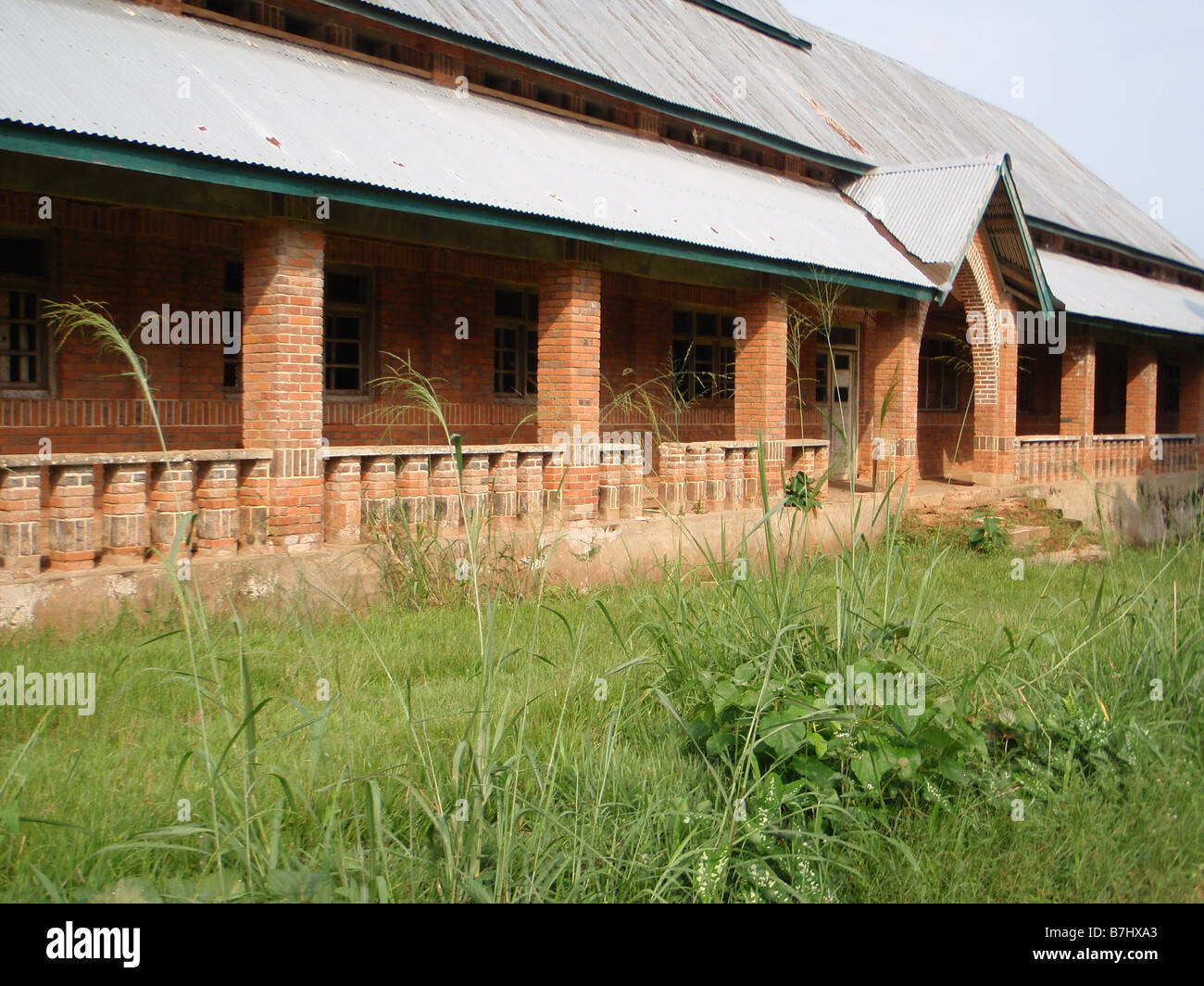 Old deserted Catholic Mission building of red brick with corrugated iron roof in Ubundu Democratic Republic of Congo Stock Photo