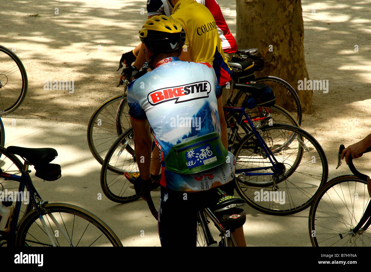 Cyclists resting under the shade of trees, France Stock Photo