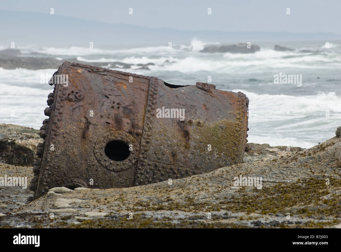 Rusty Steamship Boiler that has been in this place since the ship wrecked in 1898, Pacific Rim National Park, B.C. Stock Photo