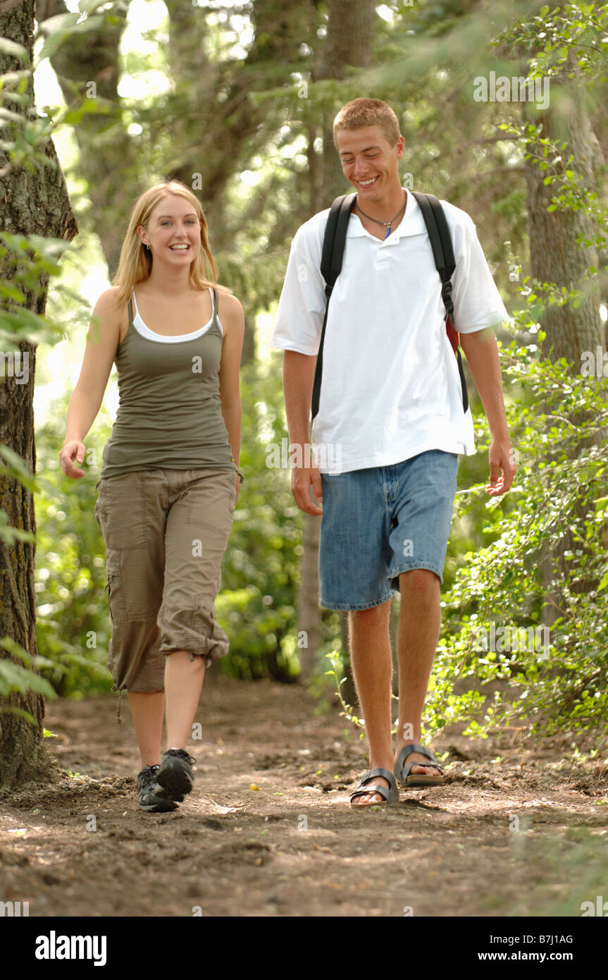 Young couple walking in woods, Regina, Saskatchewan Stock Photo