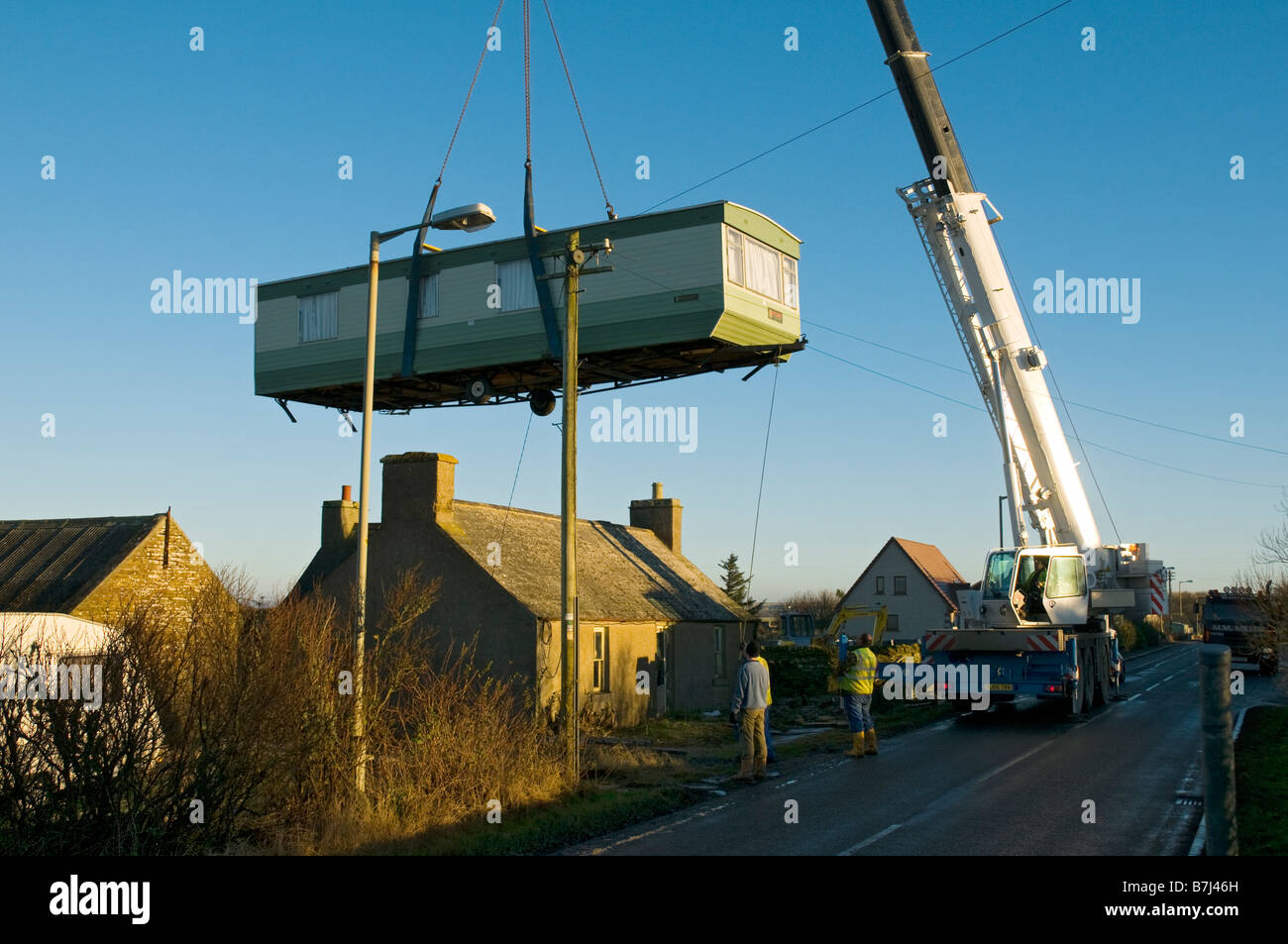 Crane lifting mobile home over hires stock photography and images Alamy