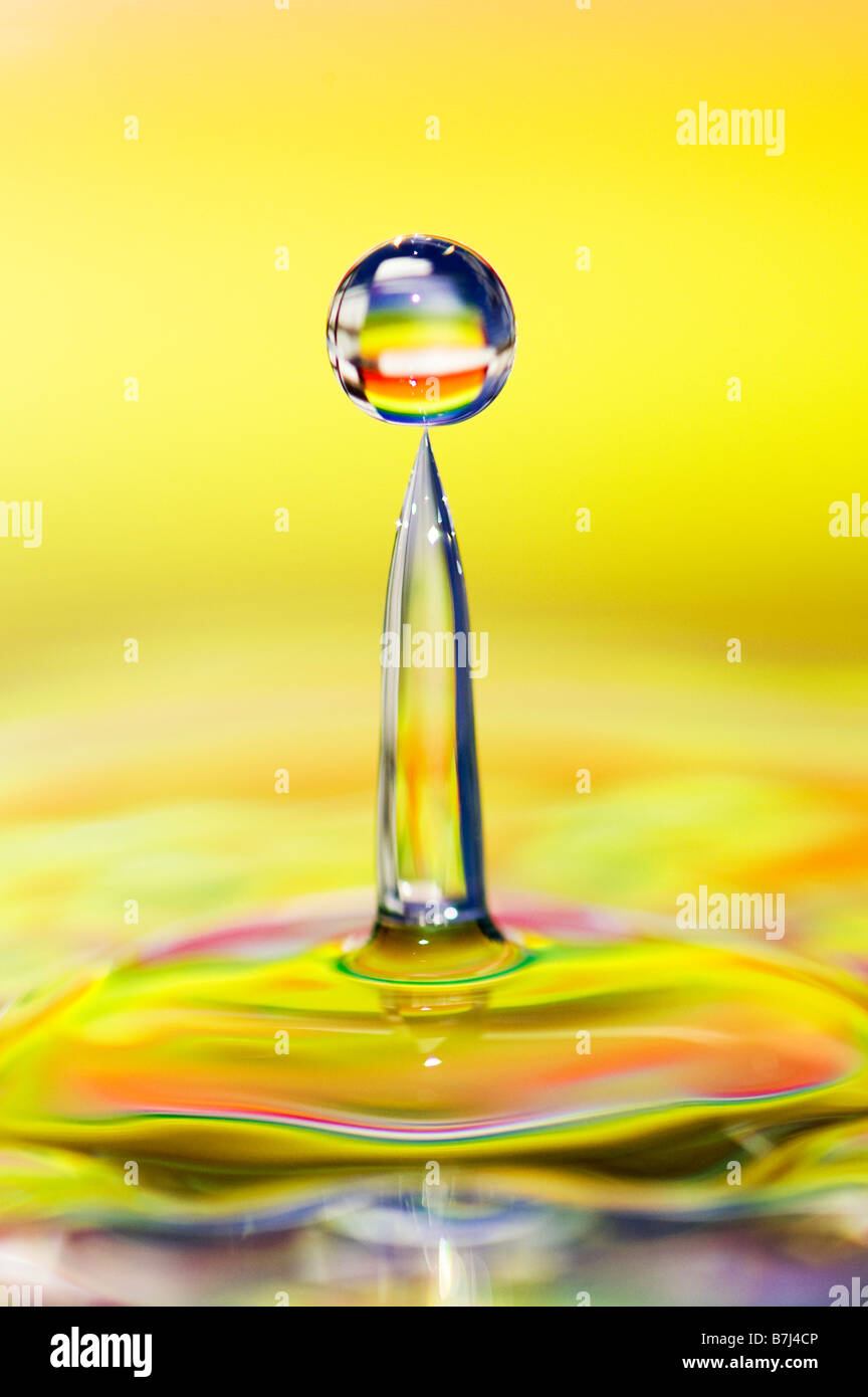Rainbow coloured water drop and ripple Stock Photo