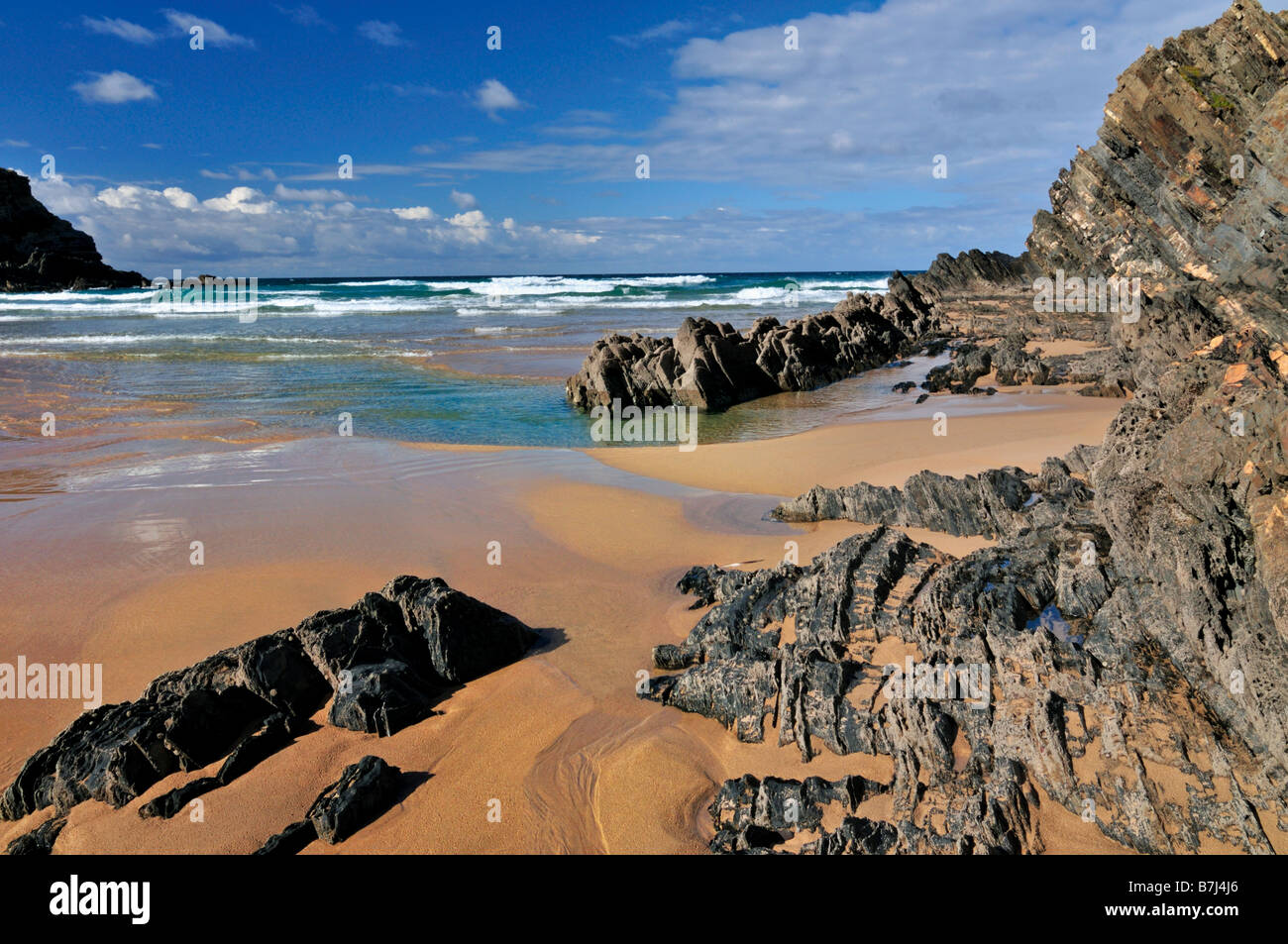 Rocks and low tide at beach of Carvalhal, Alentejo coast, Portugal Stock Photo
