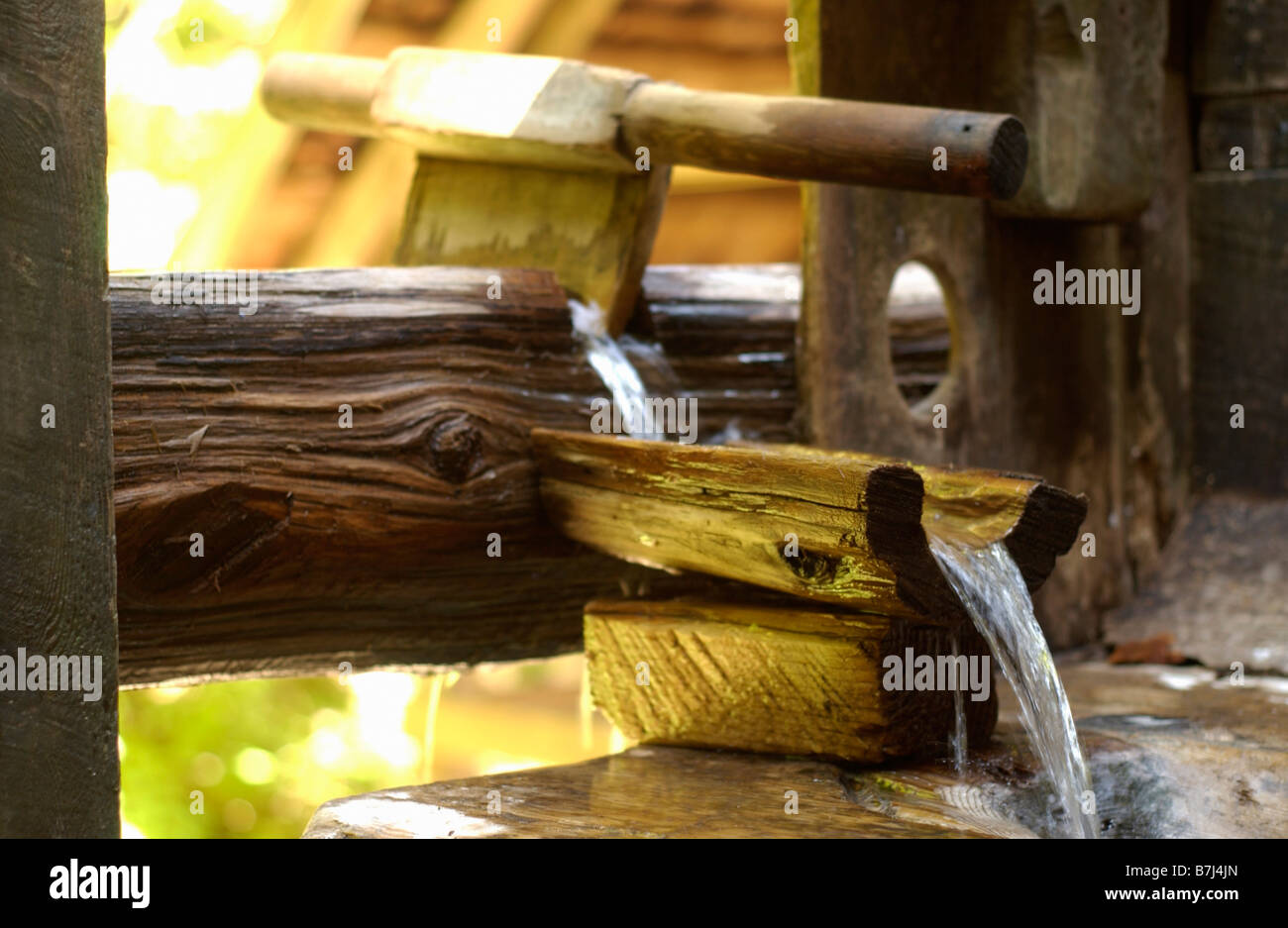 Hollowed out cedar logs transport hot spring water into hollowed out