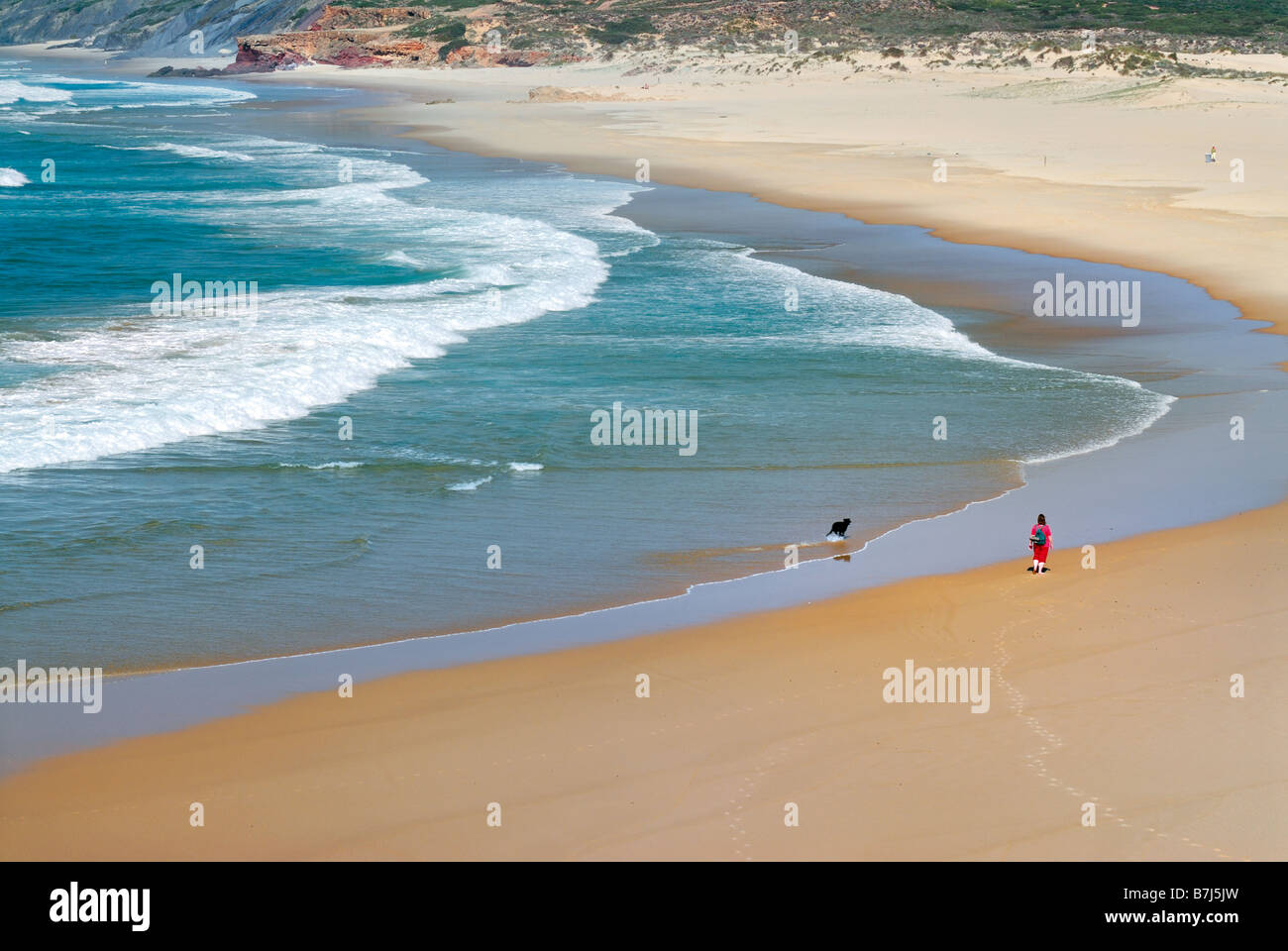 People walking at beach Praia da Bordeira inside Nature Park Costa Vicentina in the western Algarve Stock Photo