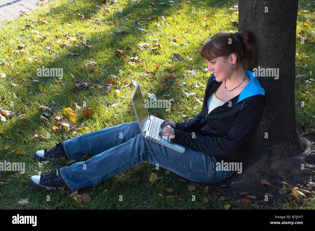 Young woman using laptop outdoors, Brantford, Ontario Stock Photo - Alamy