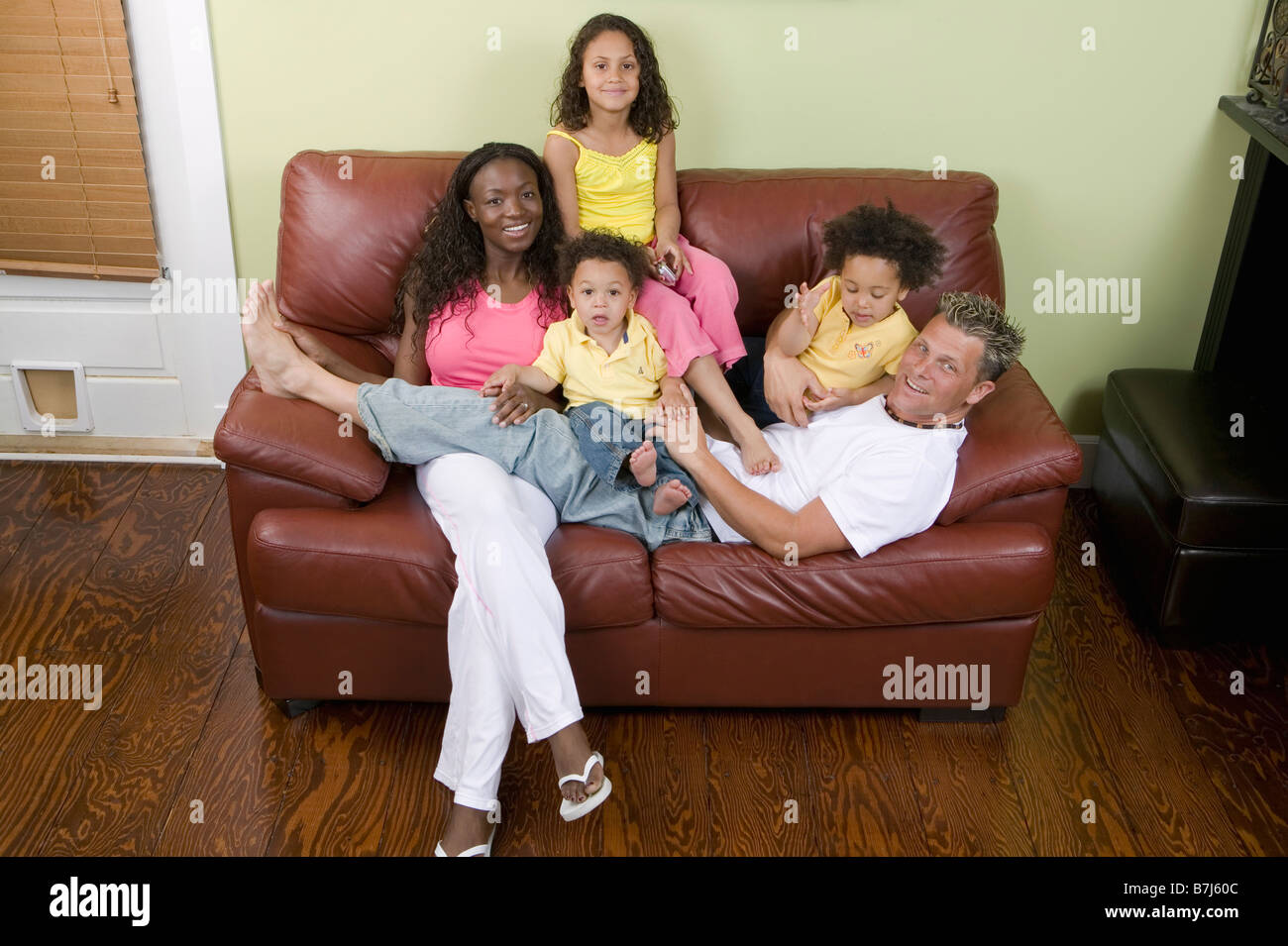 AA mom, Caucasian dad, Mulatto Children, Boy 1.5 years, girl 3 years, girl 6 years. Stock Photo