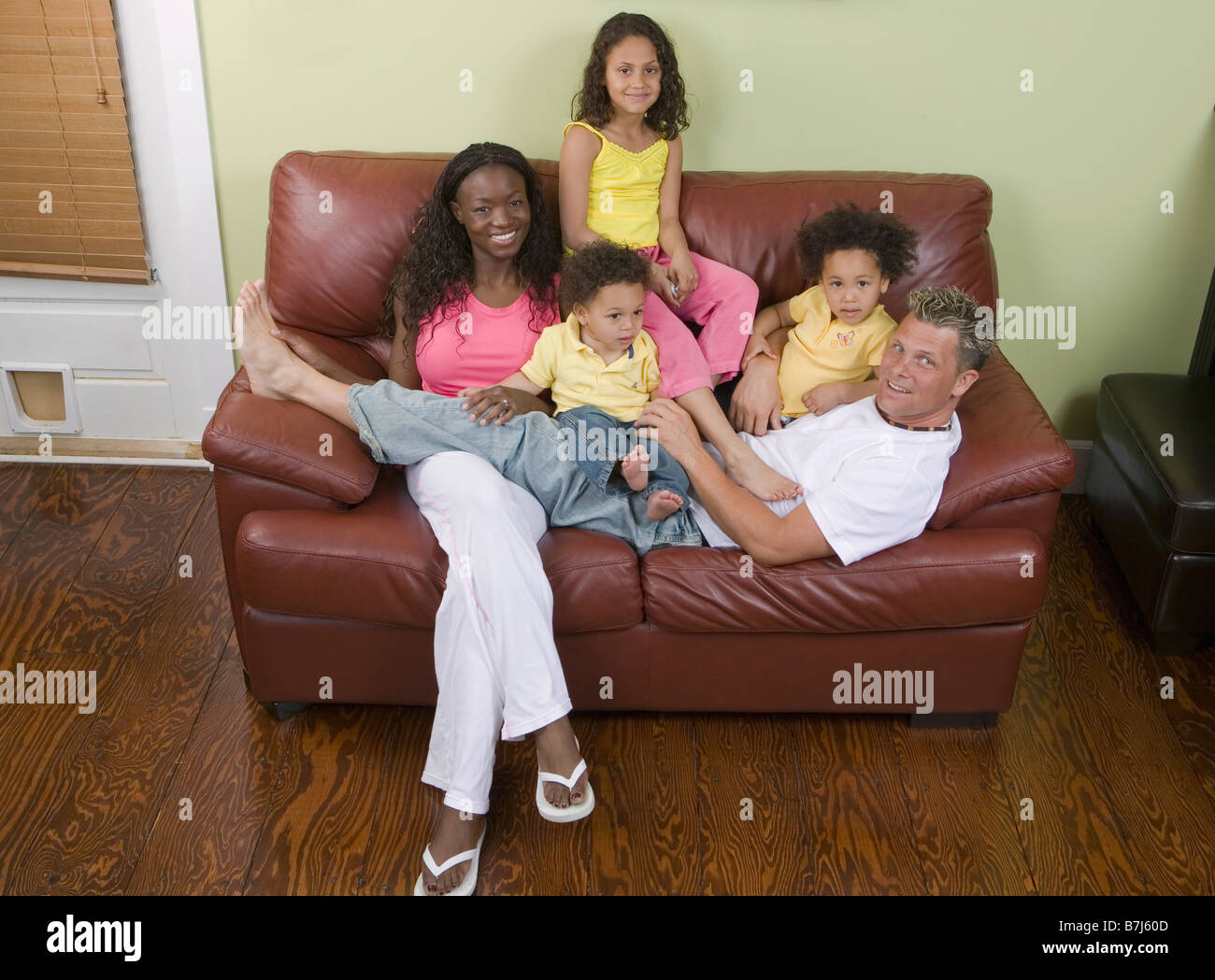 AA mom, Caucasian dad, Mulatto Children, Boy 1.5 years, girl 3 years, girl 6 years. Stock Photo