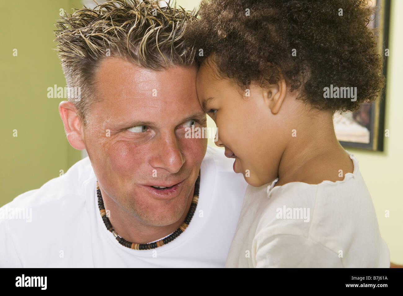 Caucasian father and Mulatto girl 3 years old. Stock Photo