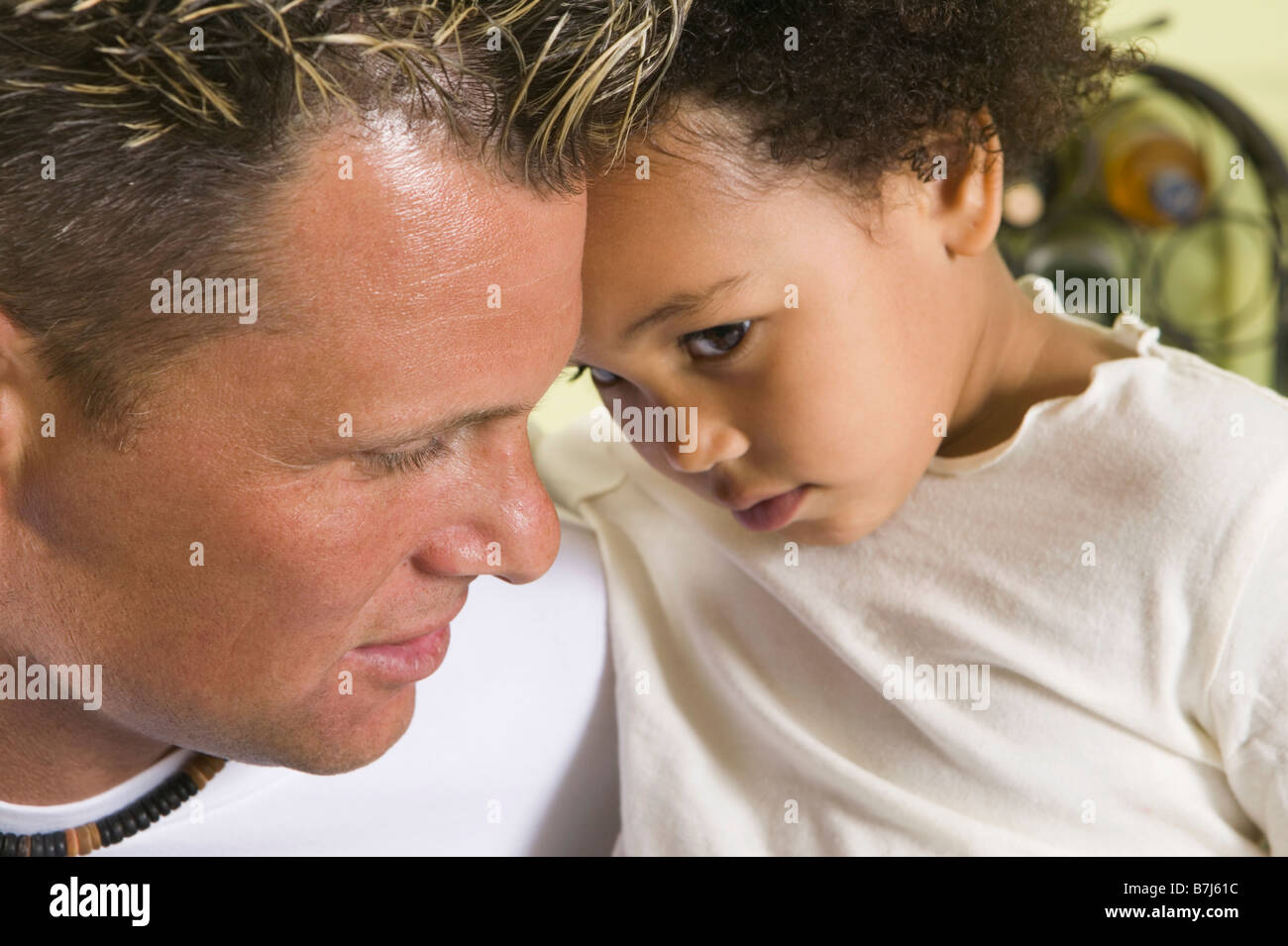 Caucasian father and Mulatto girl 3 years old. Stock Photo