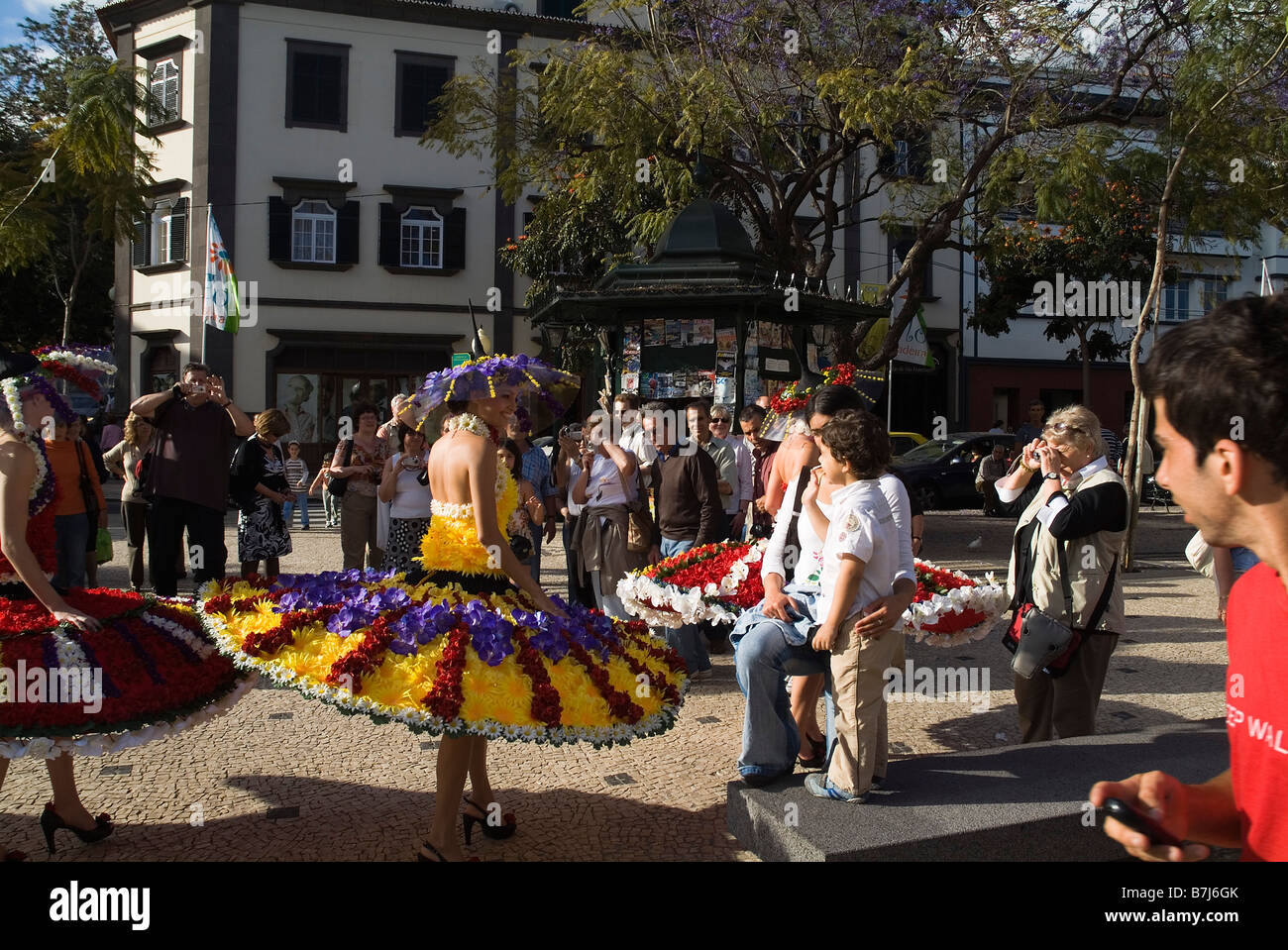 dh Flower Festival FUNCHAL MADEIRA Girl in flower costume talking to crowd girls Stock Photo