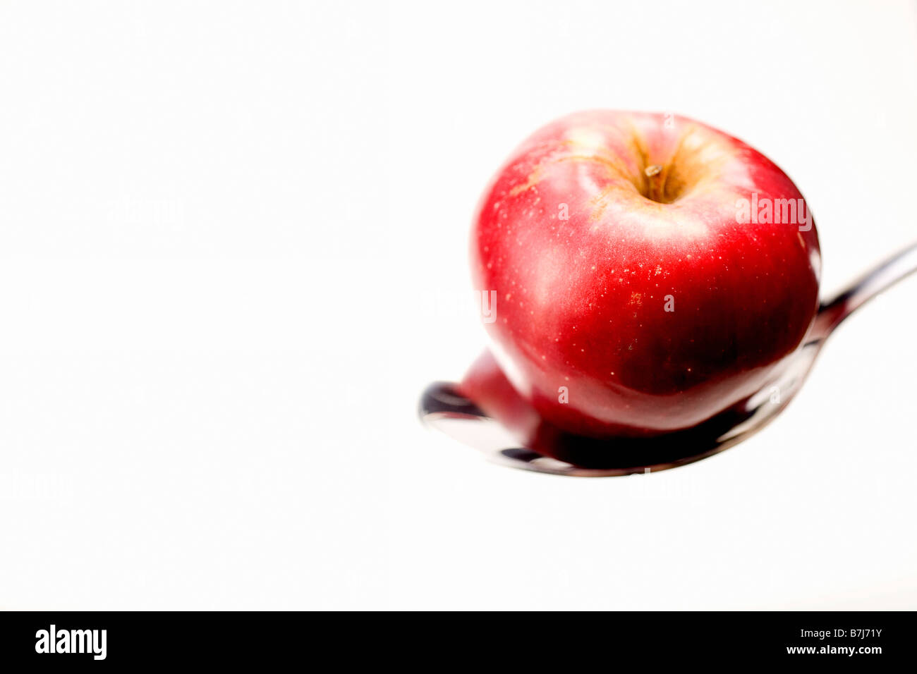 Organic apple in spoon Stock Photo
