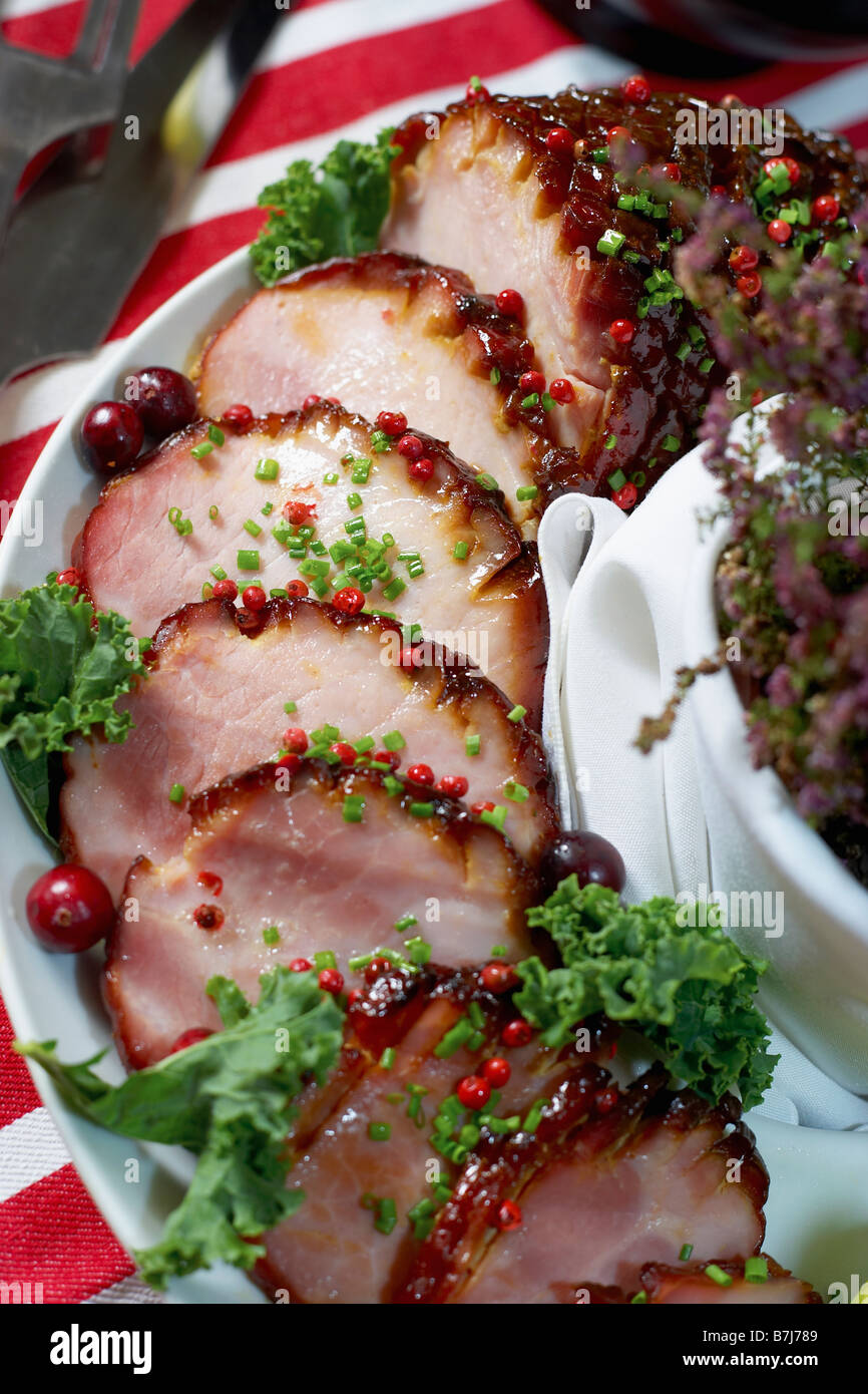 Festive oven roasted ham sliced and garnished with chives and