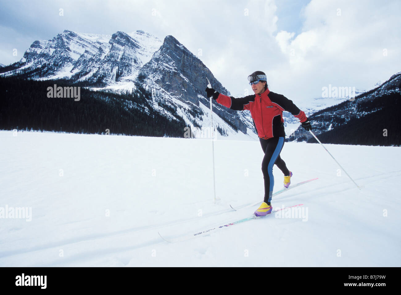Young woman cross country skiing on Lake Louise, Banff National Park, Alberta, Canada Stock