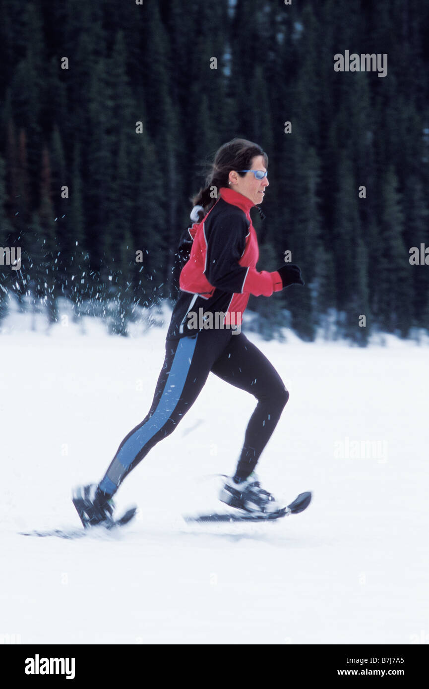 Young woman snowshoeing on Lake Louise, Banff National Park, Alberta