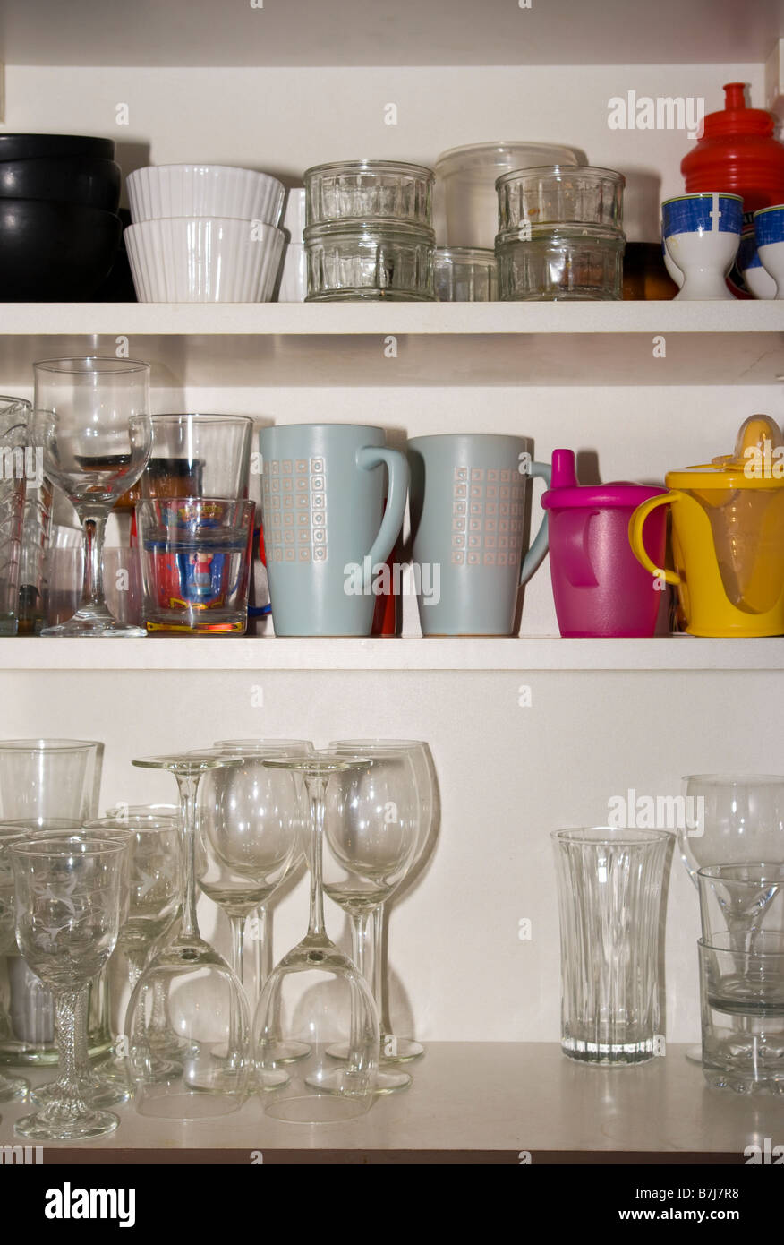 open Kitchen Cupboard Cupboards Containing Glasses and Crockery Stock Photo