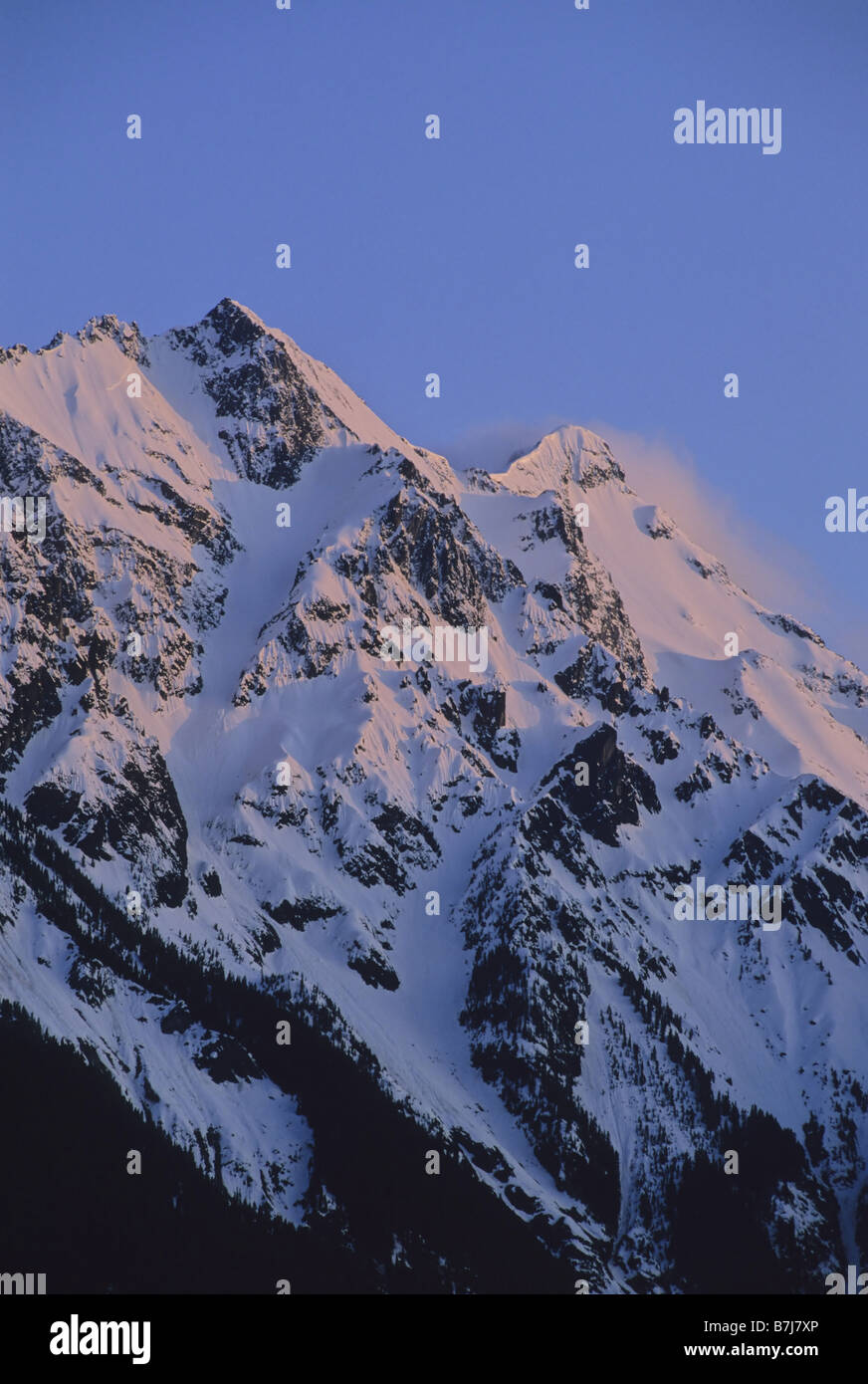 Mount Currie rises above Pemberton Valley, alpenglow lights snow