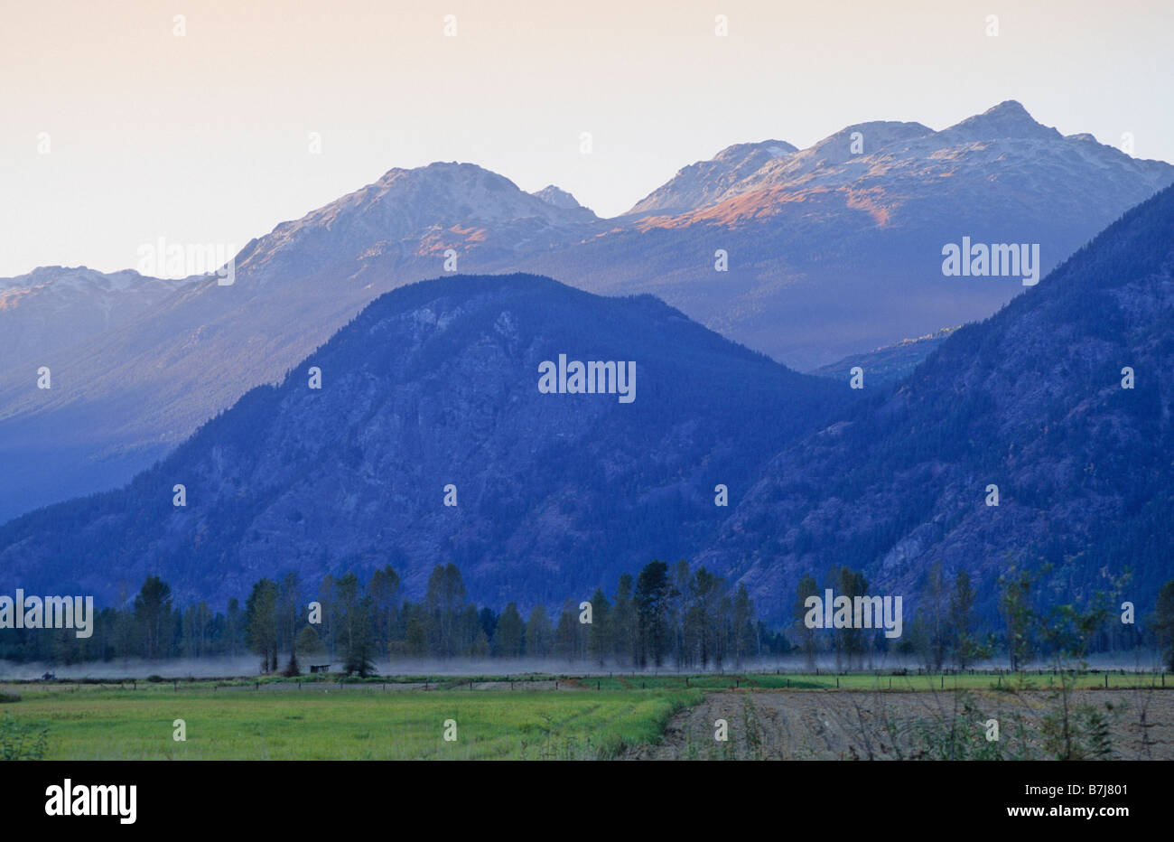 Mountains rise in late summer day above Pemberton Valley Stock Photo