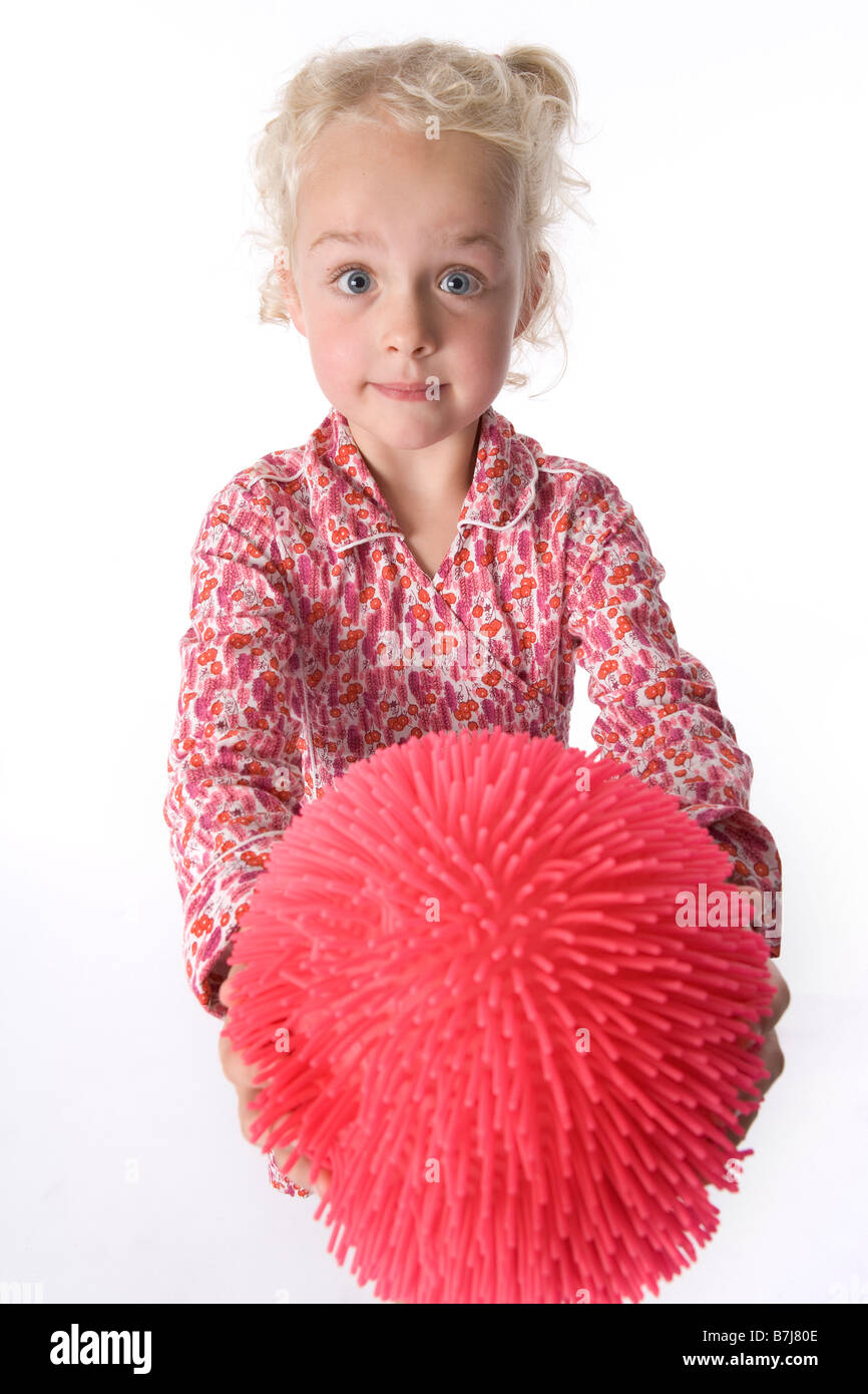 Little girl shows an odd ball Stock Photo