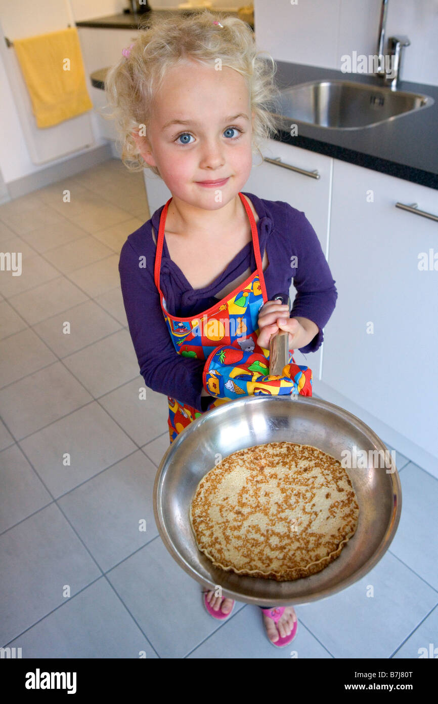 Little girl show her self made pancakes Stock Photo