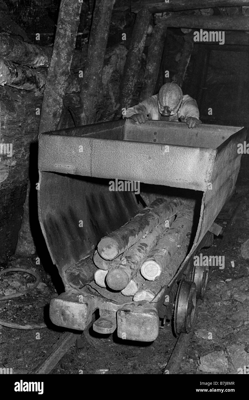 Miners pushing tram of pit props to the coalface underground at Blaencuffin coal mine in the mountainside above Pontypool Torfaen South Wales UK Stock Photo