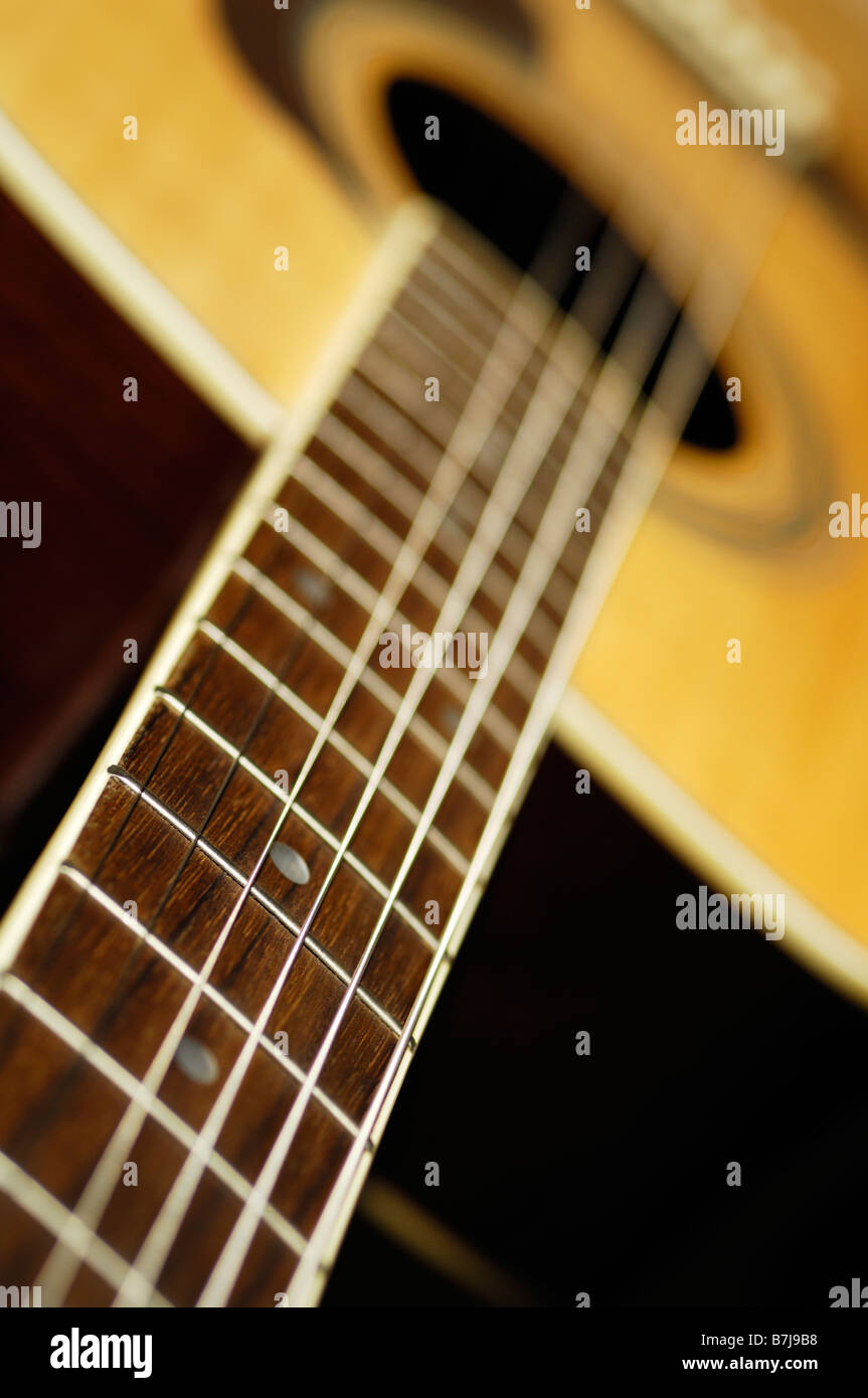 A close up of the fret board of a steel strung folk acoustic guitar. Stock Photo