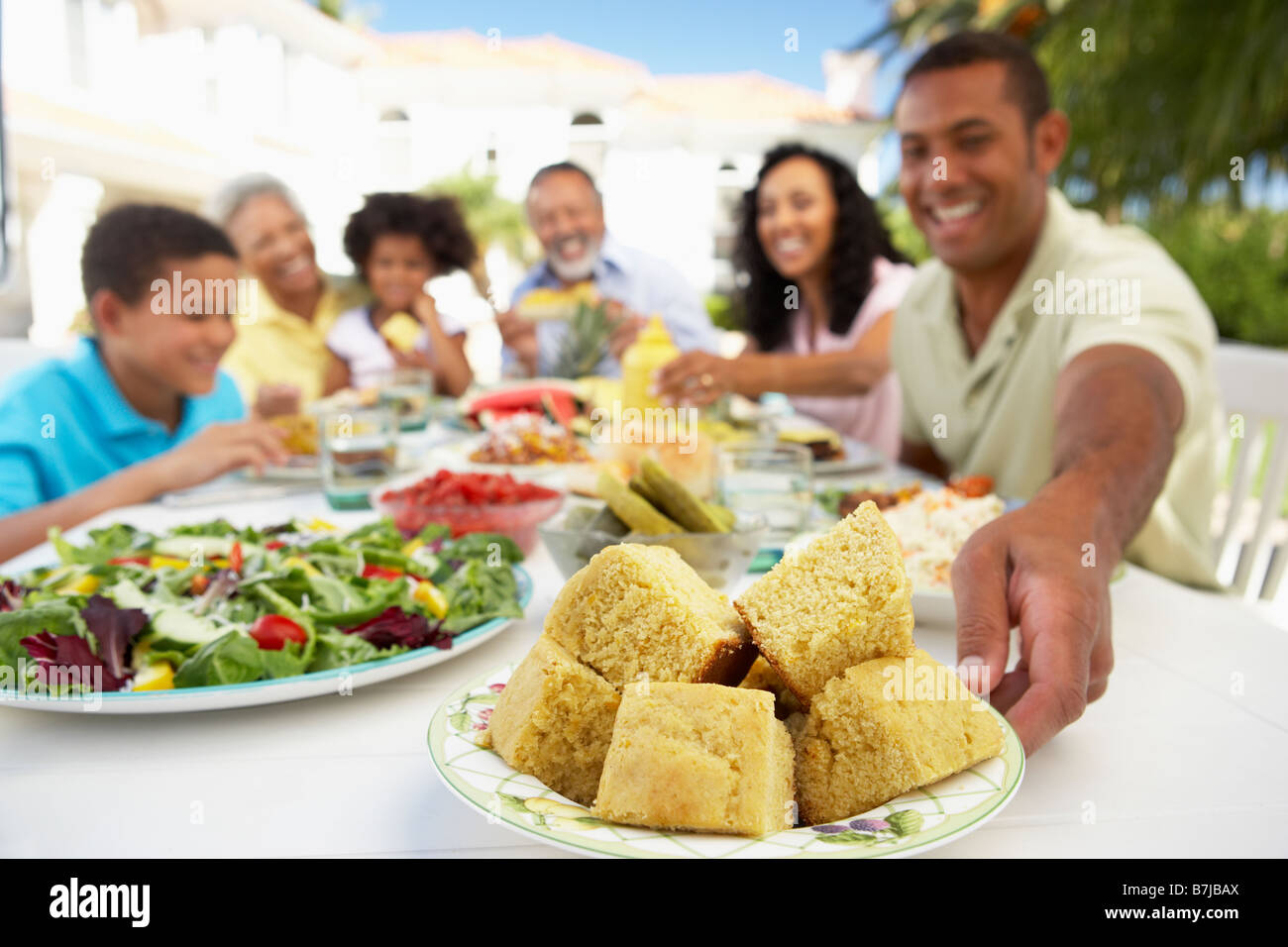 Family Eating An Al Fresco Meal Stock Photo