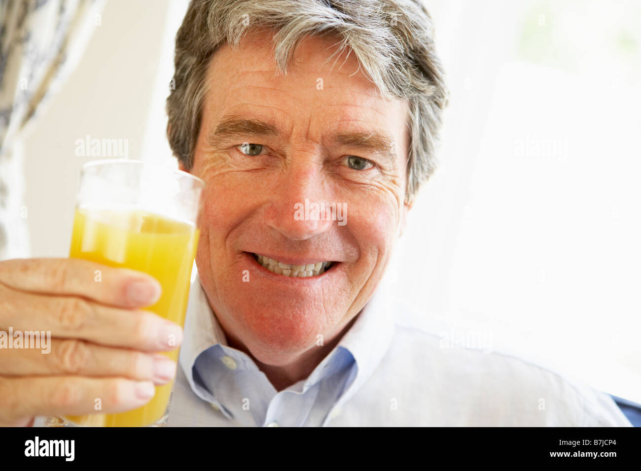 Senior Man Drinking Orange Juice High Resolution Stock Photography And Images Alamy