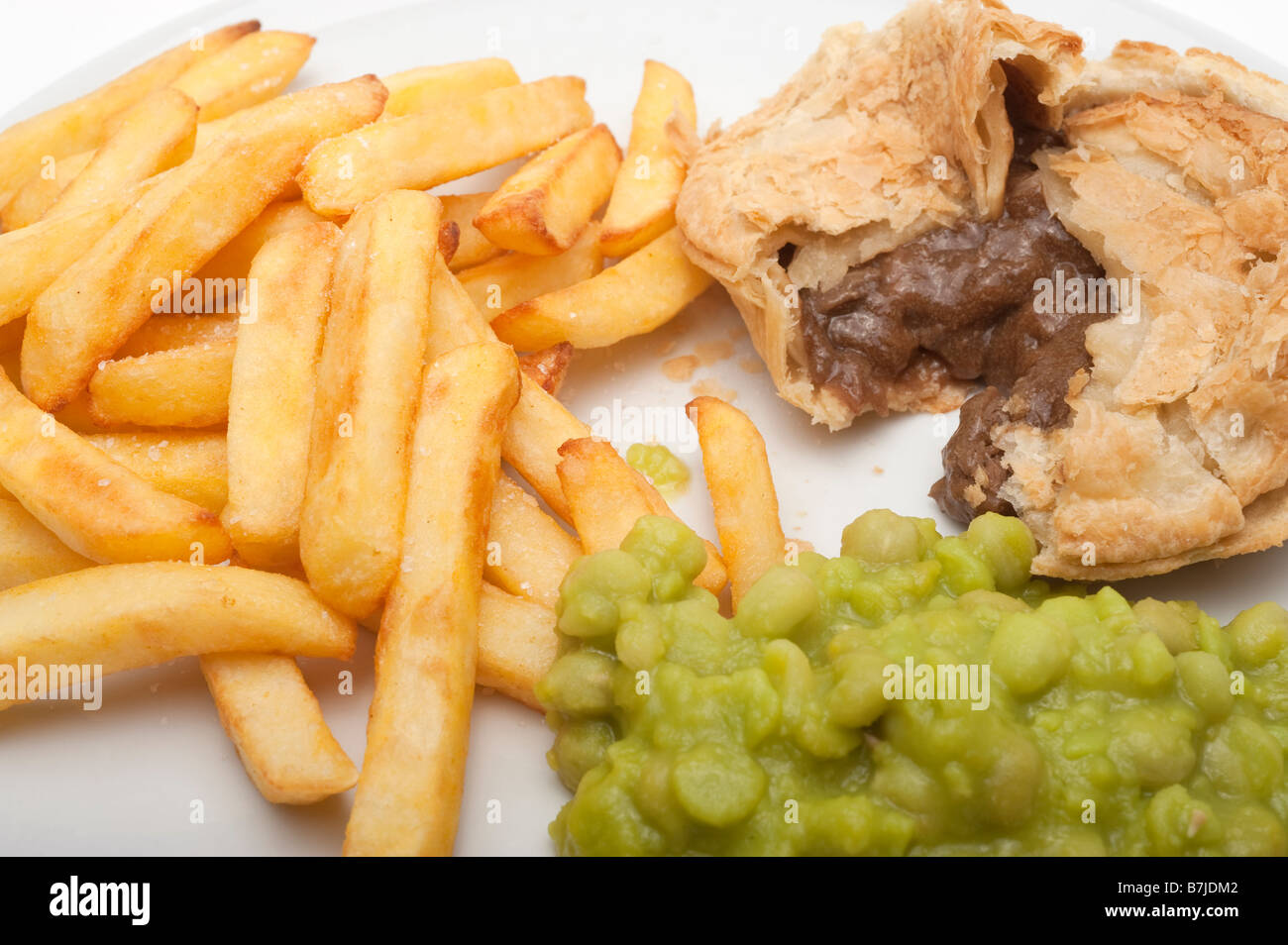 Chips meat pie and mushy peas Stock Photo