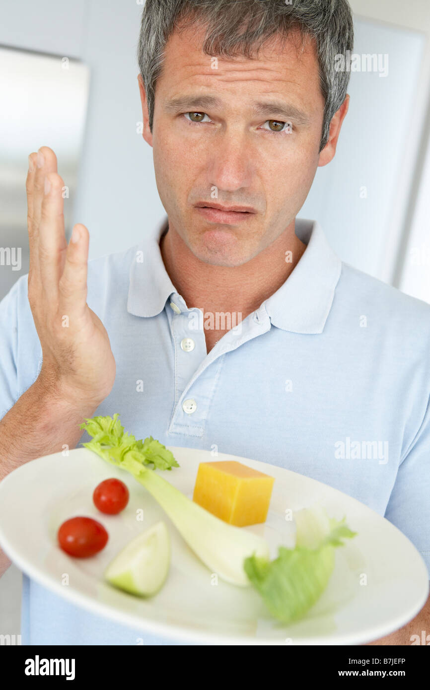 Middle Aged Man Holding A Plate Of Fresh And Healthy Food Stock Photo
