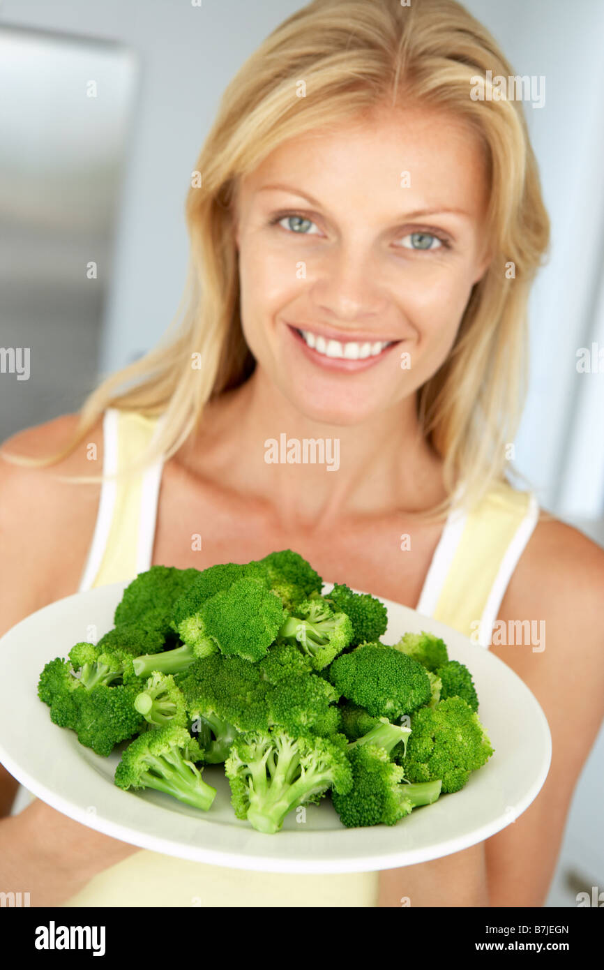 Mid Adult Woman Holding A Plate Of Broccoli Stock Photo Alamy