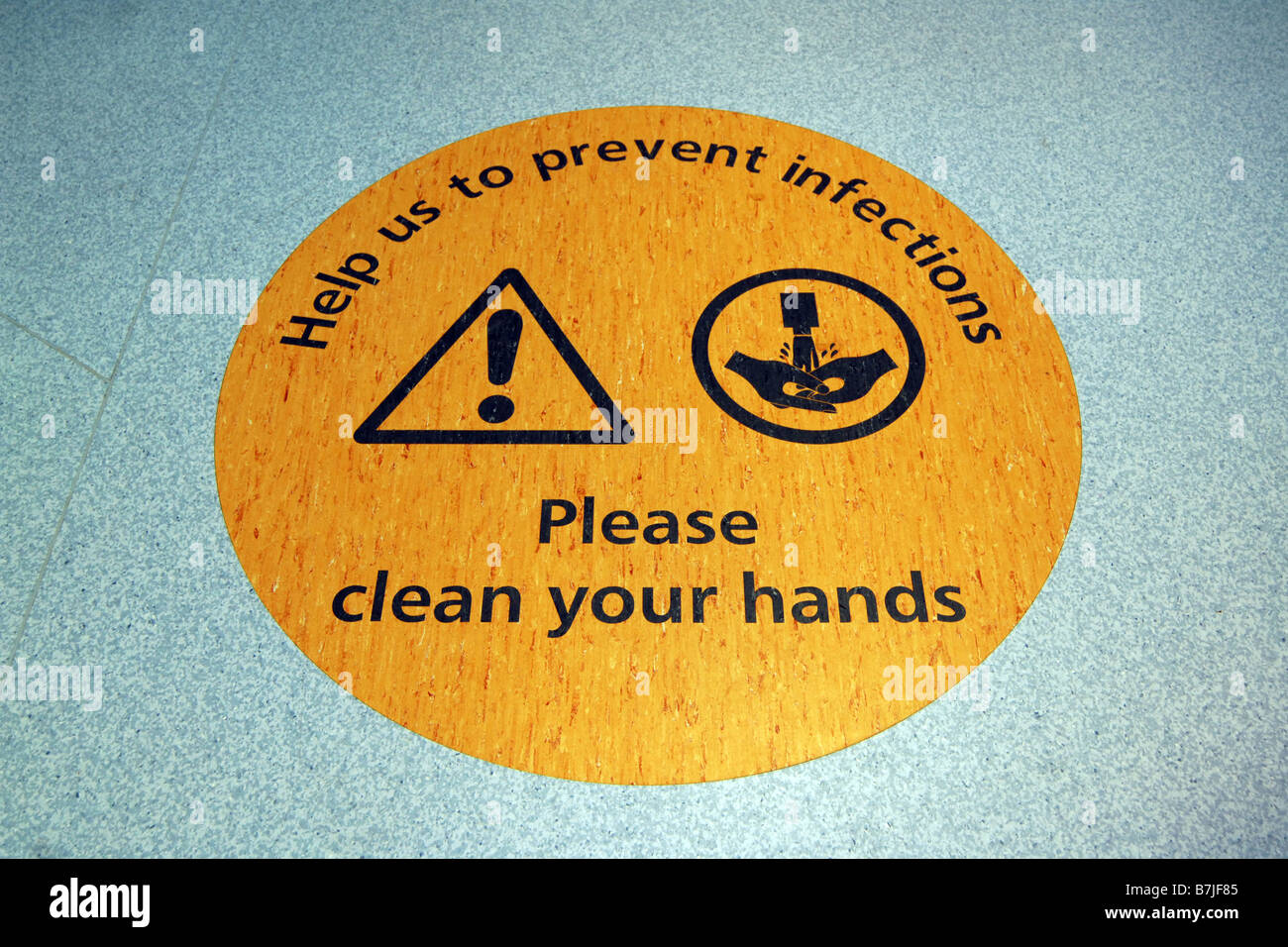 A floor sign at a Yorkshire hospital reminds staff and public to wash their hands to stop the spread of infection Stock Photo