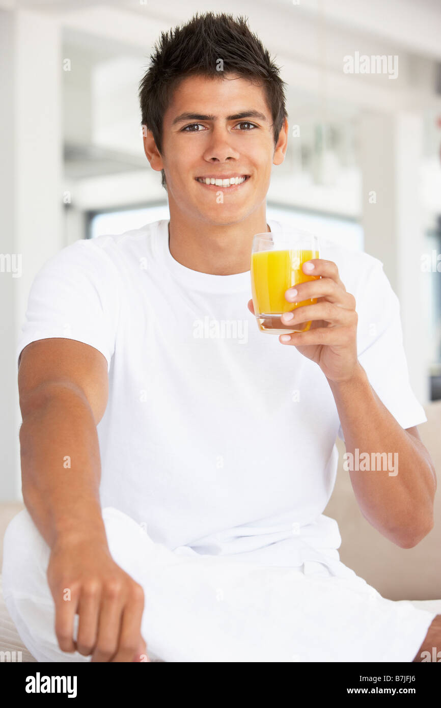 Young Man Drinking Orange Juice Stock Photo Alamy