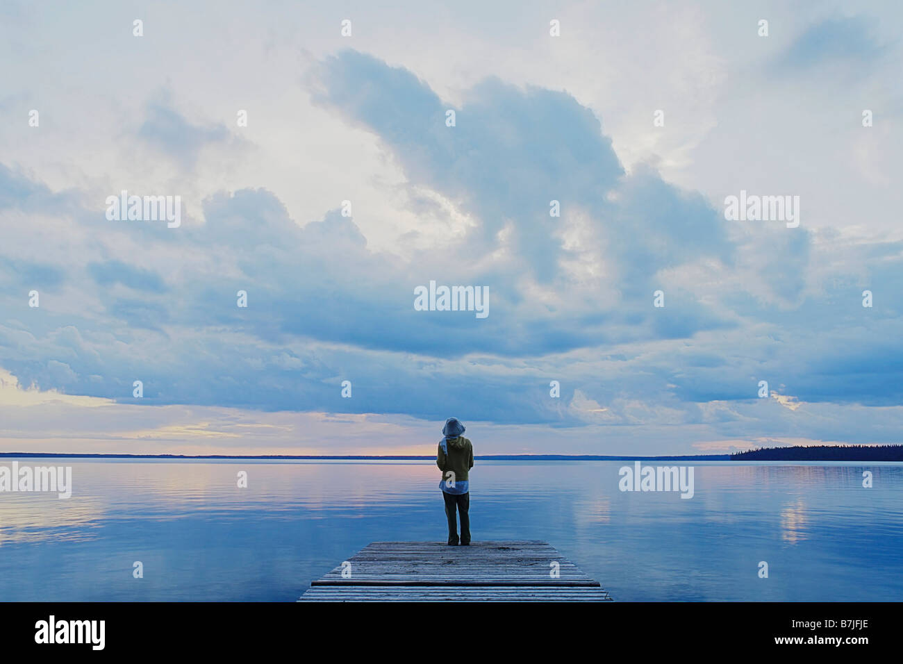 Woman on public dock Clear Lake; Canada, Manitoba, Riding Mountain