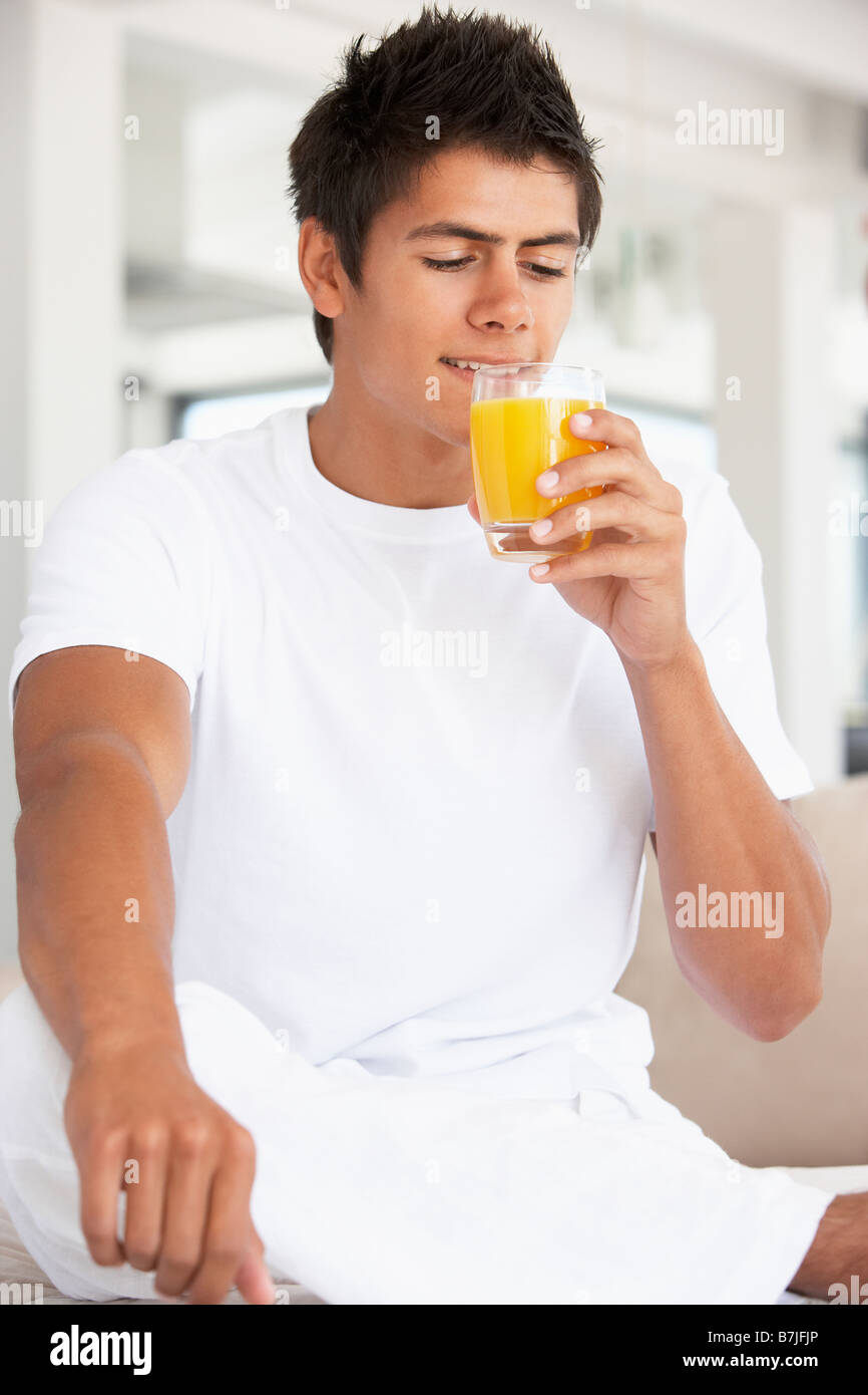 Young Man Drinking Orange Juice Stock Photo Alamy