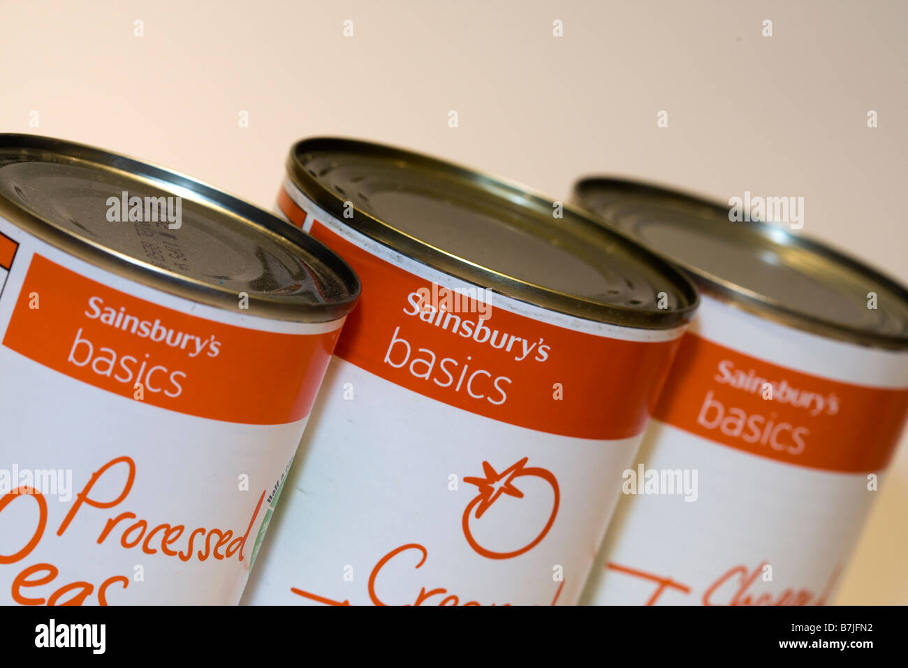 Three tins of Sainsburys Basics economy range tinned food Stock Photo