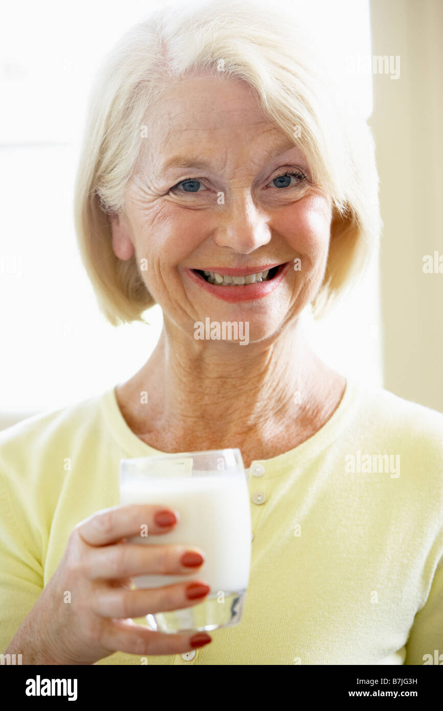 Senior Woman Drinking Milk Stock Photo Alamy
