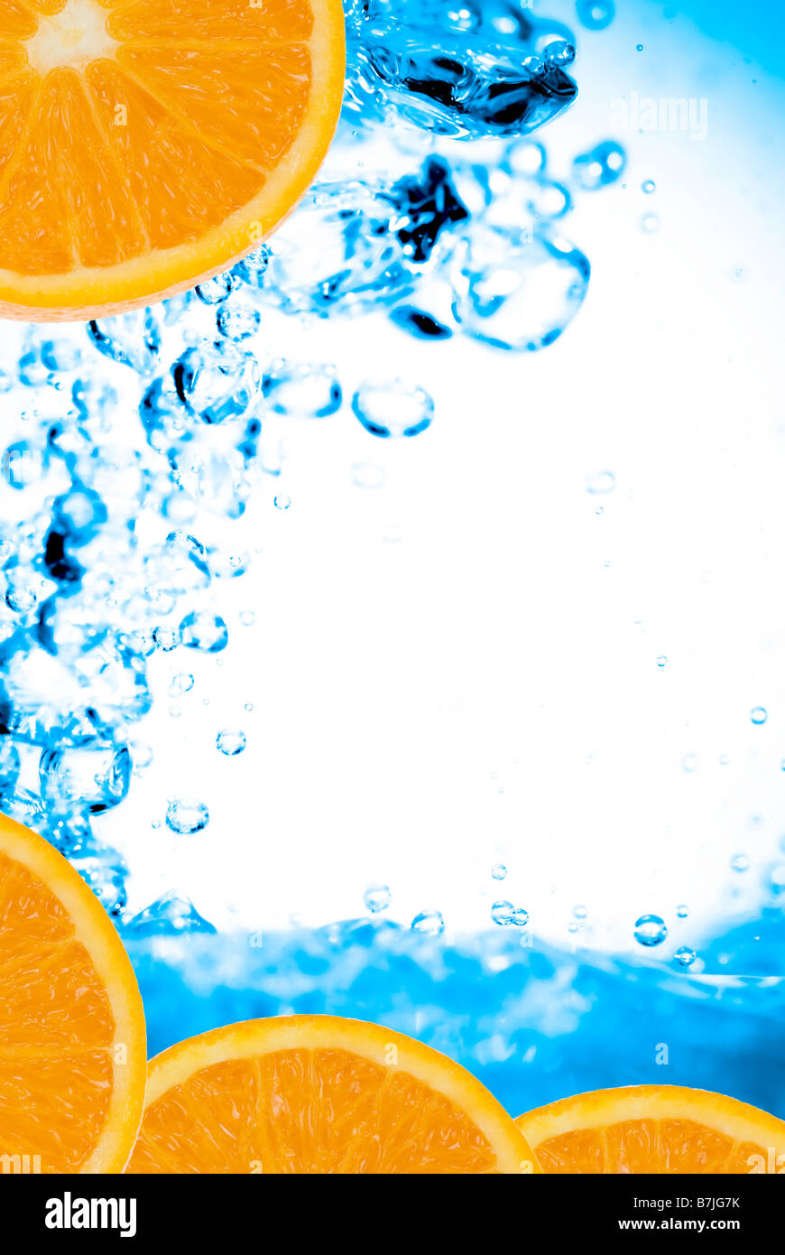 fresh oranges and splashing water Stock Photo
