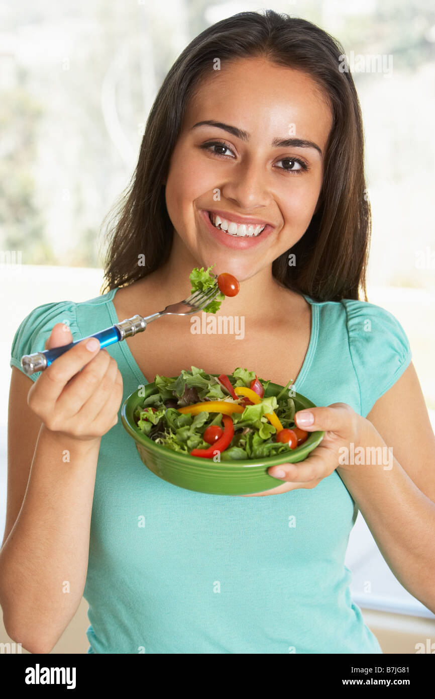 Hispanic teen girl eating a salad hires stock photography and images