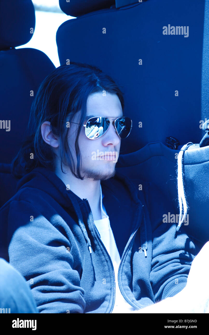Monochromatic blue portrait of a young man wearing sunglasses Stock ...