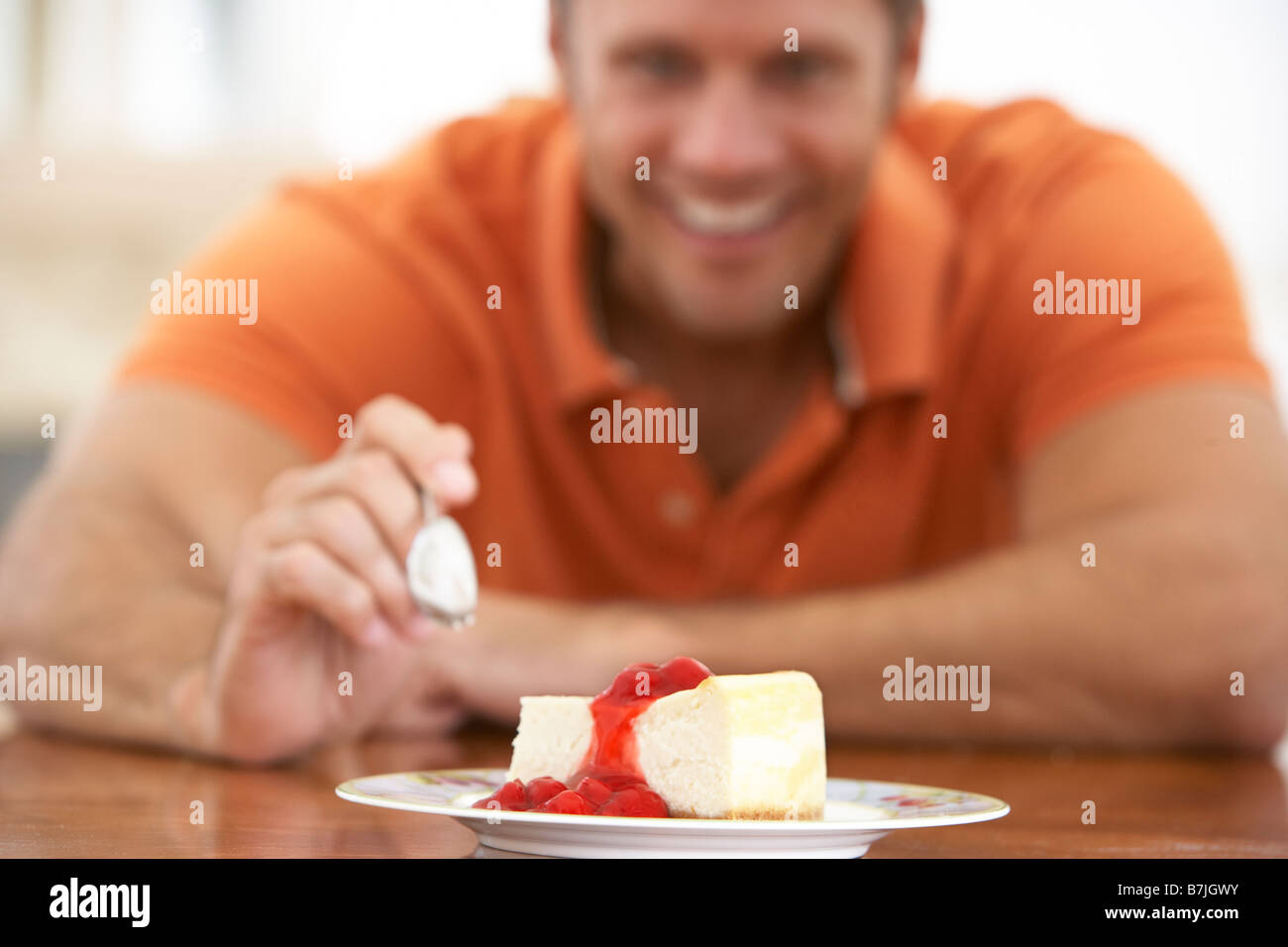 Middle Aged Man Eating Cheesecake Stock Photo