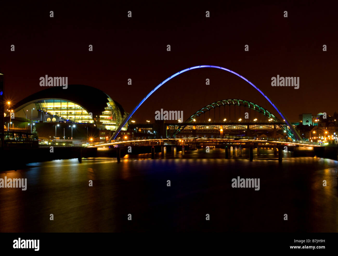 Night time view of the Sage Gateshead also the  Millennium, Tyne and High level bridges joining Newcastle to Gateshead Stock Photo