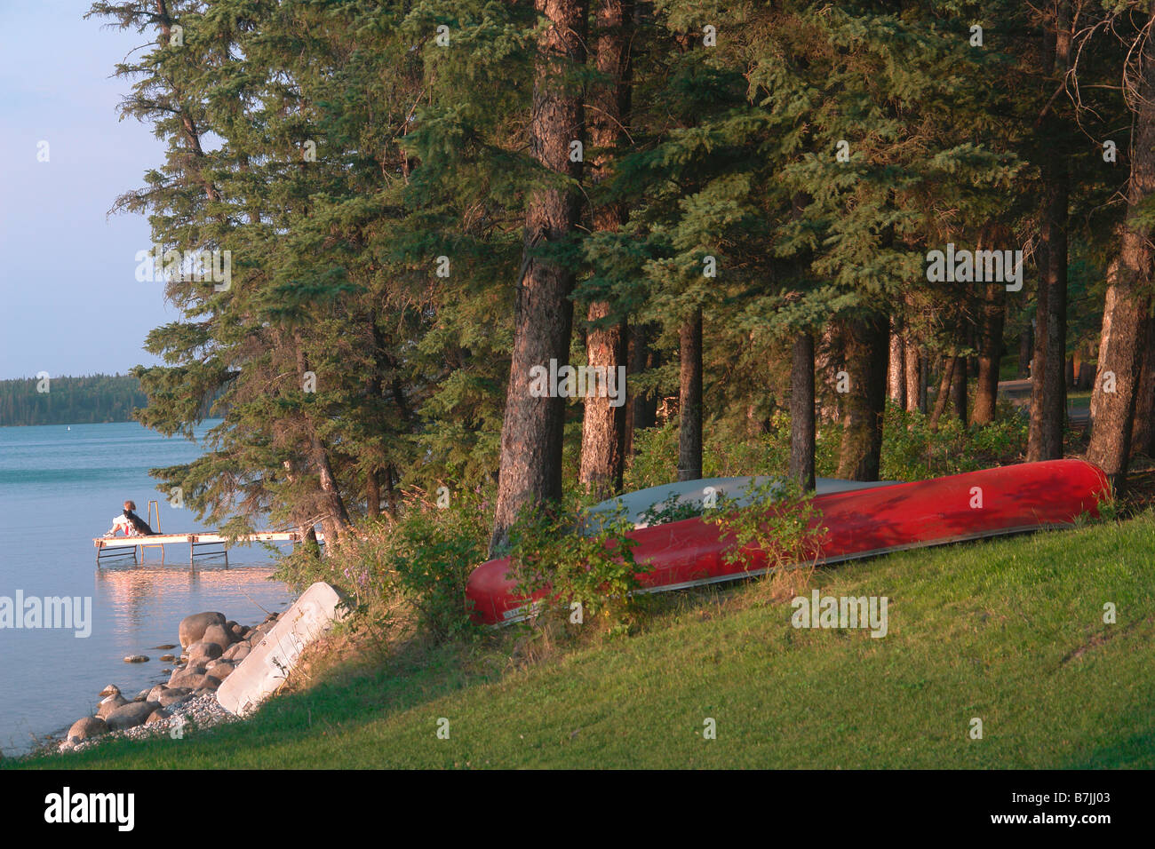 Woman on dock Clear Lake; Canada, Manitoba, Riding Mountain National