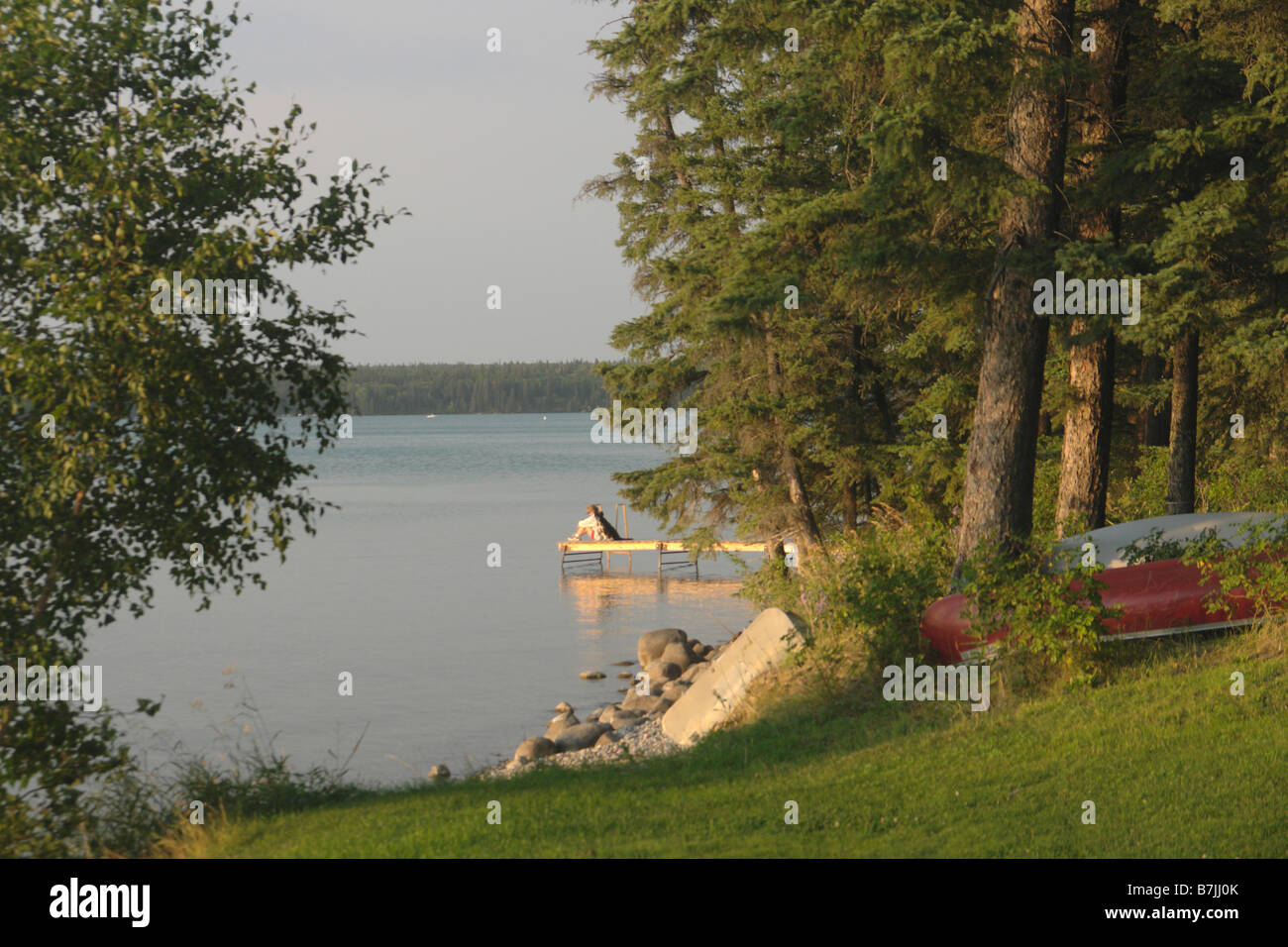 Woman on dock Clear Lake; Canada, Manitoba, Riding Mountain National
