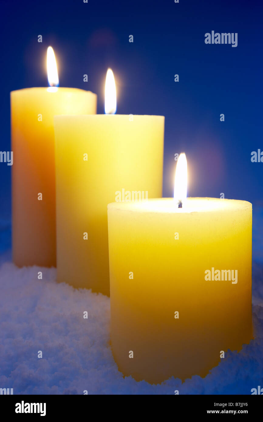 Group Of Lit Candles In Snow Stock Photo