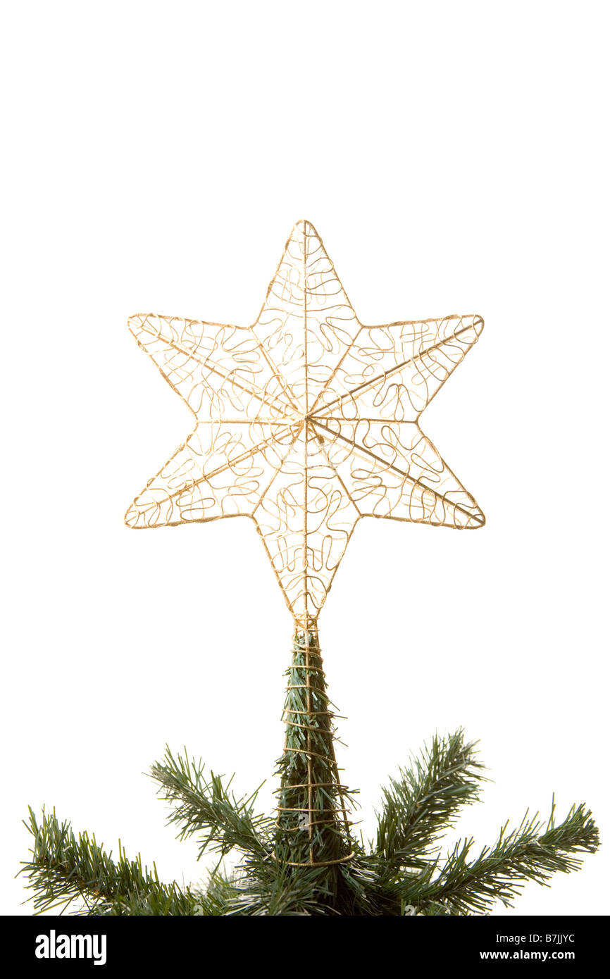 Gold Star On Top Of Christmas Tree Against White Background Stock Photo